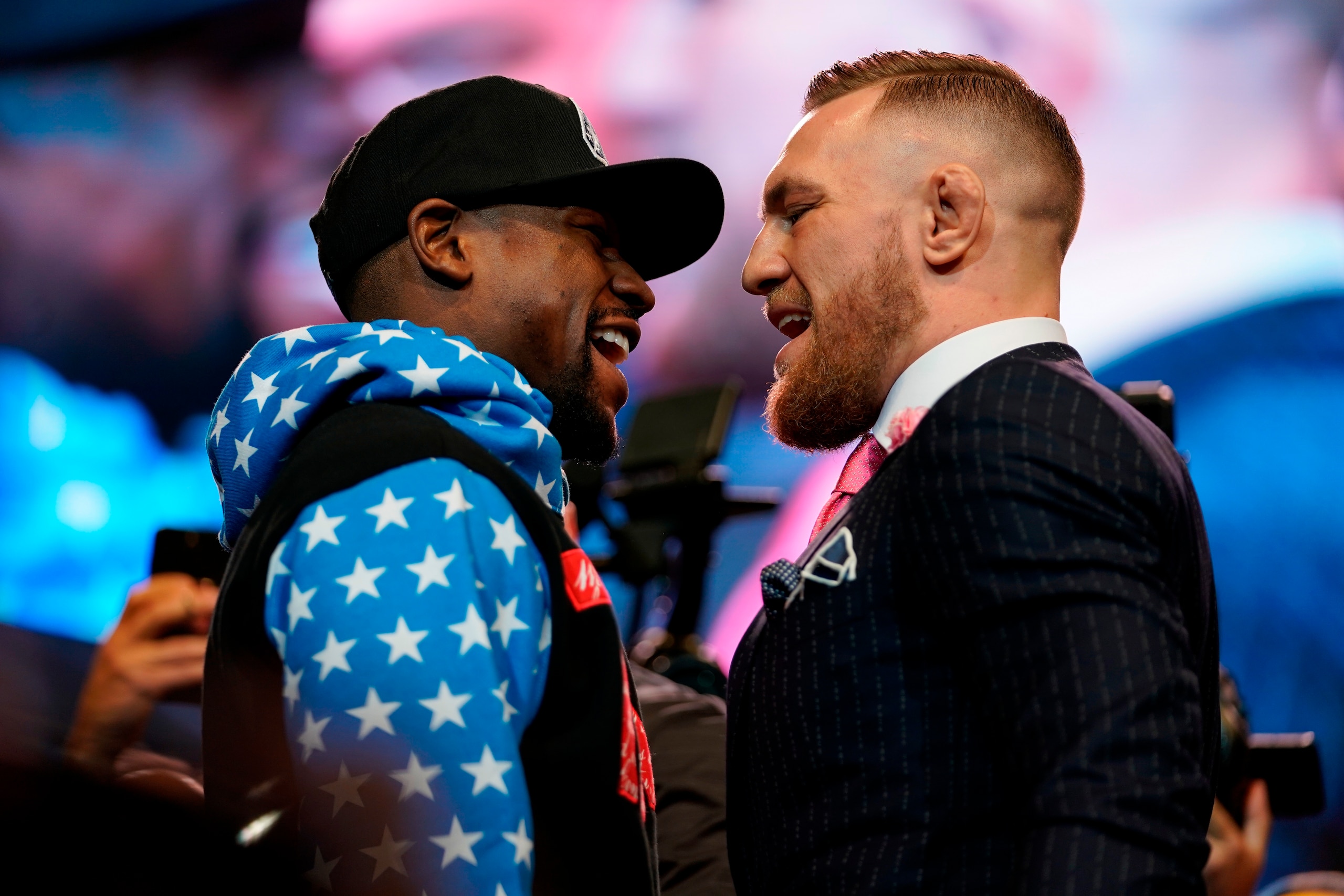 LOS ANGELES, CA - JULY 11:  (L-R) Floyd Mayweather Jr. and Conor McGregor face off during the Floyd Mayweather Jr. v Conor McGregor World Press Tour event at the Staples Center on July 11, 2017 in Los Angeles, California. (Photo by Jeff Bottari/Zuffa LLC/