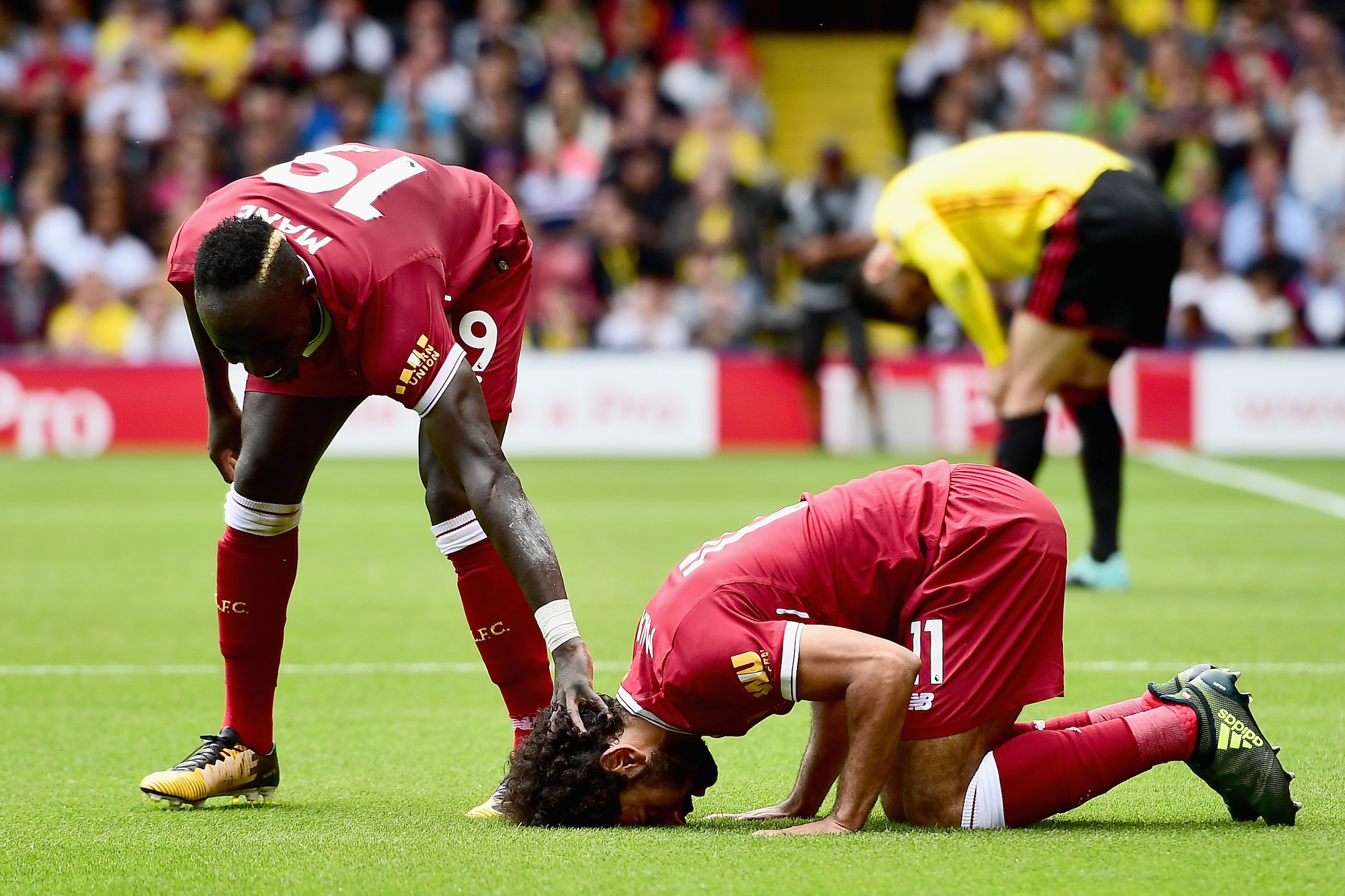 WATFORD, ENGLAND - AUGUST 12: Mohamed Salah of Liverpool celebrates scoring his sides third goal with Sadio Mane of Liverpool during the Premier League match between Watford and Liverpool at Vicarage Road on August 12, 2017 in Watford, England.  (Photo by