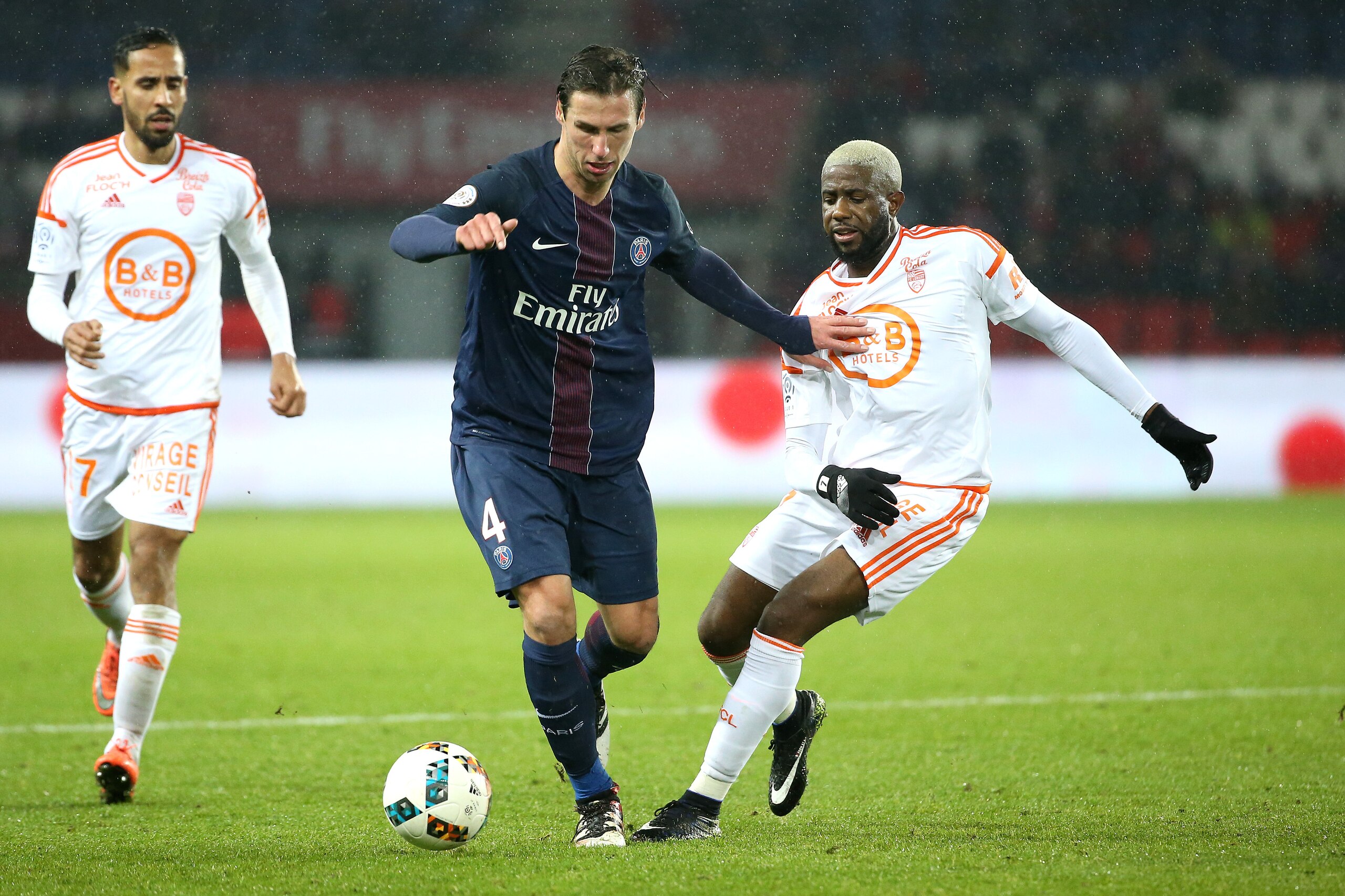 PARIS, FRANCE - DECEMBER 21: Grzegorz Krychowiak of PSG and Arnold Mvuemba of Lorient in action during the French Ligue 1 match between Paris Saint-Germain (PSG) and FC Lorient at Parc des Princes stadium on December 21, 2016 in Paris, France. (Photo by J