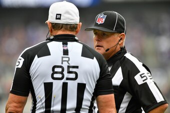 BALTIMORE, MD - OCTOBER 2:  Line judge Rusty Baynes #59 confers with referee Ed Hochuli #85 during the game between the Baltimore Ravens and the Oakland Raiders at M&T Bank Stadium on October 2, 2016 in Baltimore, Maryland. The Raiders defeated the Ravens