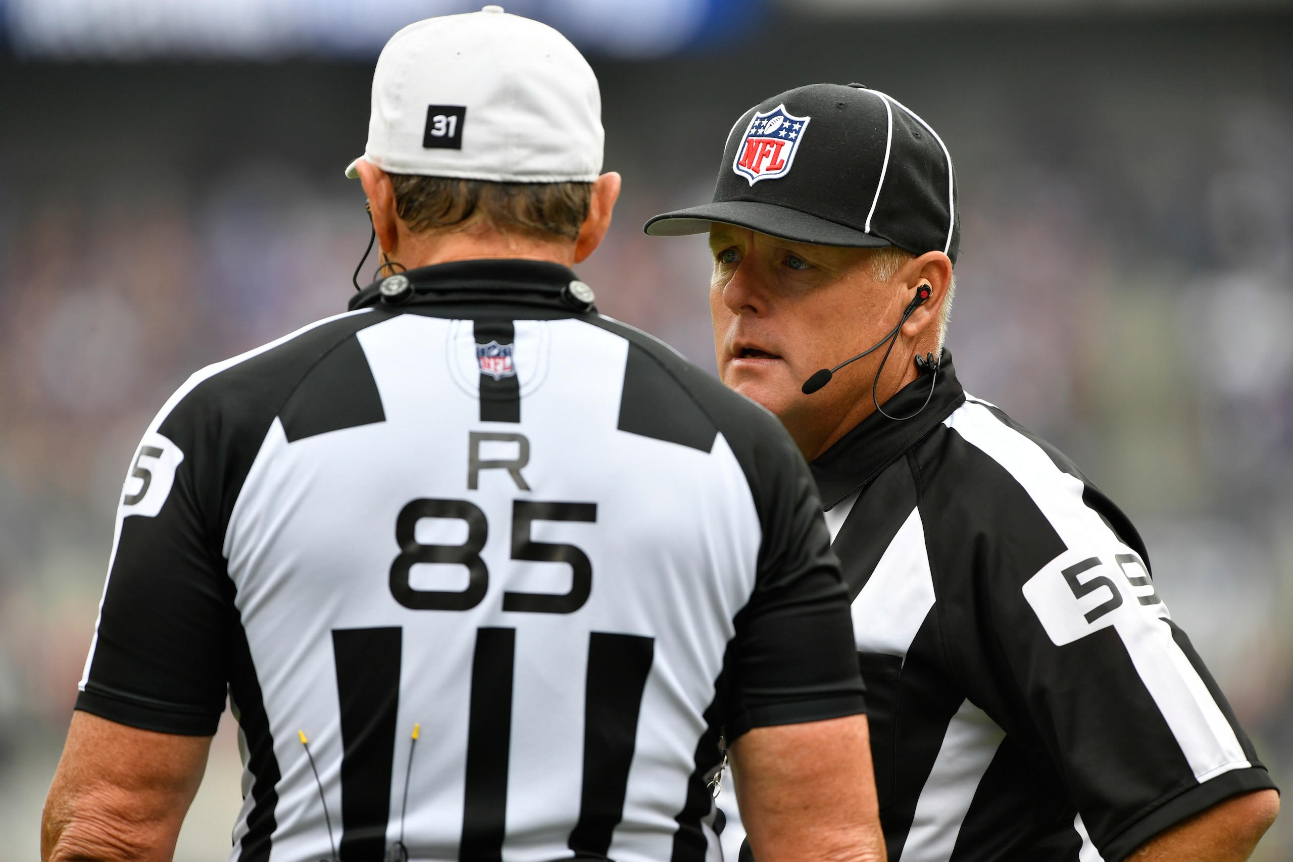 BALTIMORE, MD - OCTOBER 2:  Line judge Rusty Baynes #59 confers with referee Ed Hochuli #85 during the game between the Baltimore Ravens and the Oakland Raiders at M&T Bank Stadium on October 2, 2016 in Baltimore, Maryland. The Raiders defeated the Ravens