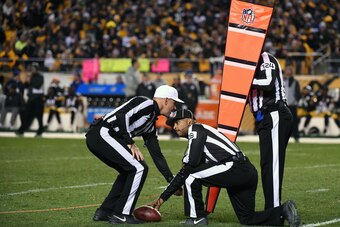 PITTSBURGH, PA - NOVEMBER 13: National Football League officials, referee Clete Blakeman (white hat), field judge Adrian Hill #29 and umpire Carl Paganelli #124, measure for a first down during a game between the Dallas Cowboys and the Pittsburgh Steelers