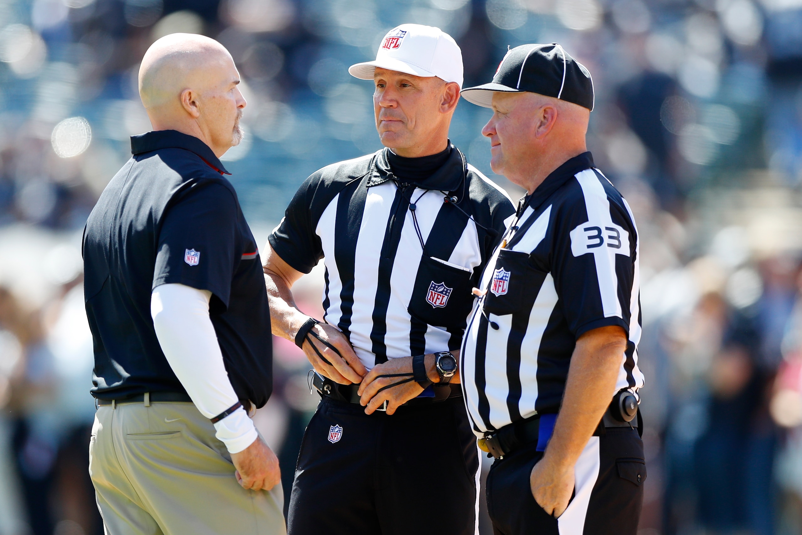 OAKLAND, CA - SEPTEMBER 18:  Head coach Dan Quinn of the Atlanta Falcons  speaks with referee Clete Blakeman and field judge Steve Zimmer prior to their NFL game against the Oakland Raiders at Oakland-Alameda County Coliseum on September 18, 2016 in Oakla