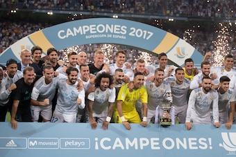 MADRID, SPAIN - AUGUST 16: Sergio Ramos of Real Madrid CF celebrates with teammates with the Supercopa de Espana trophy after beating FC Barcelona 2-0 (3-1) on aggregate in the Supercopa de Espana Final 2nd Leg match between Real Madrid and FC Barcelona a