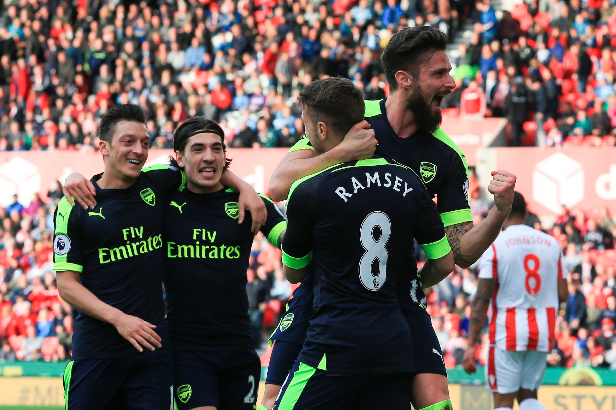 Arsenal's French striker Olivier Giroud (R) celebrates with teammates after scoring their fourth goal during the English Premier League football match between Stoke City and Arsenal at the Bet365 Stadium in Stoke-on-Trent, central England on May 13, 2017.
