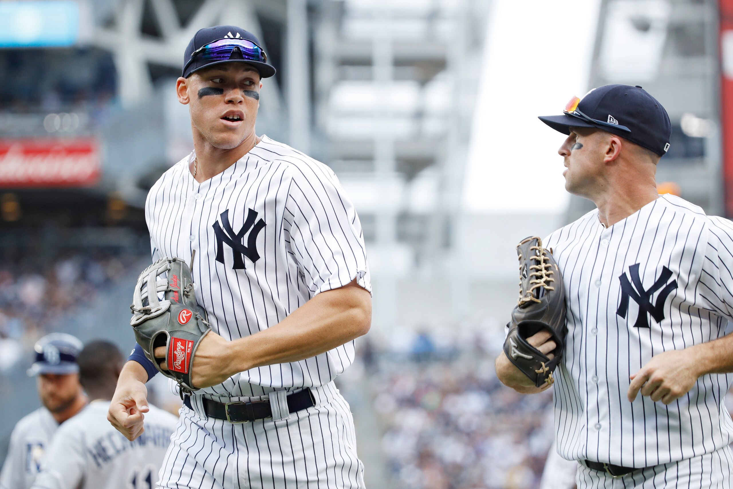 NEW YORK, NY - JULY 29: Aaron Judge #99 and Brett Gardner #11 of the New York Yankees run off the field in between innings of a game against the Tampa Bay Rays at Yankee Stadium on July 29, 2017 in the Bronx borough of New York City. The Yankees defeated 