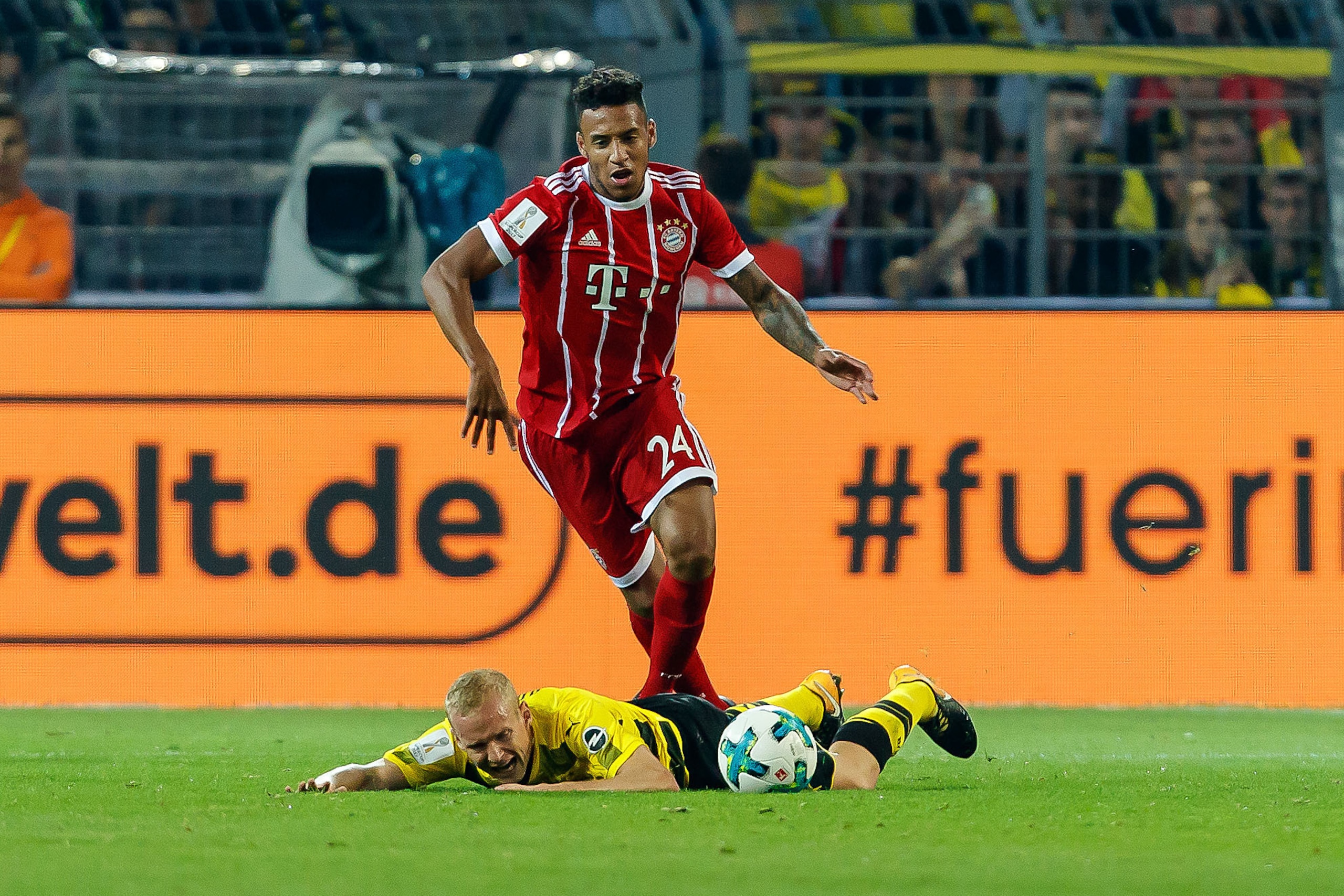DORTMUND, GERMANY - AUGUST 05: Sebastian Rode of Dortmund and Corentin Tolisso of Bayern Muenchen battle for the ball during the DFL Supercup 2017 match between Borussia Dortmund and Bayern Muenchen at Signal Iduna Park on August 5, 2017 in Dortmund, Germ