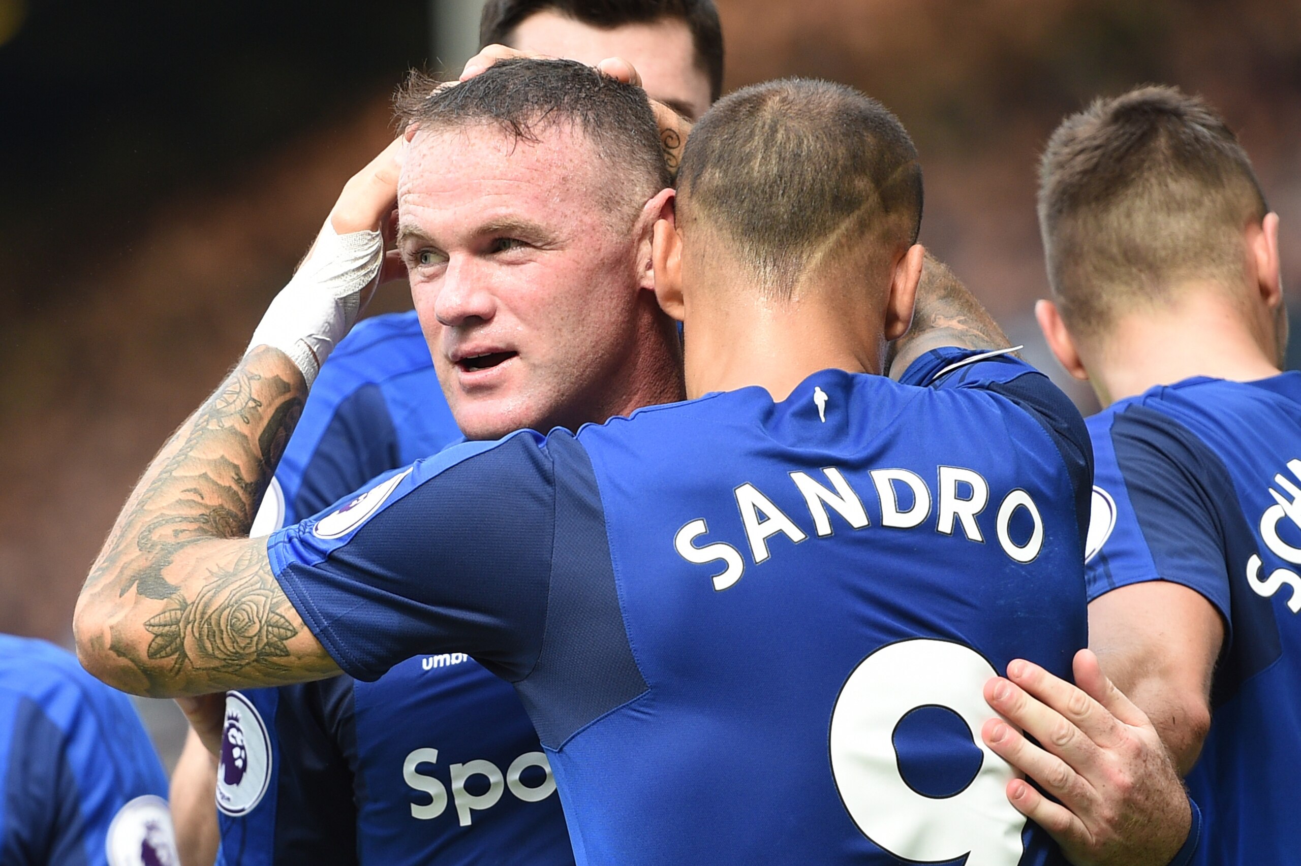 Everton's English striker Wayne Rooney celebrates scoring the opening goal with Everton's Spanish striker Sandro Ramirez during the English Premier League football match between Everton and Stoke City at Goodison Park in Liverpool, north west England on A
