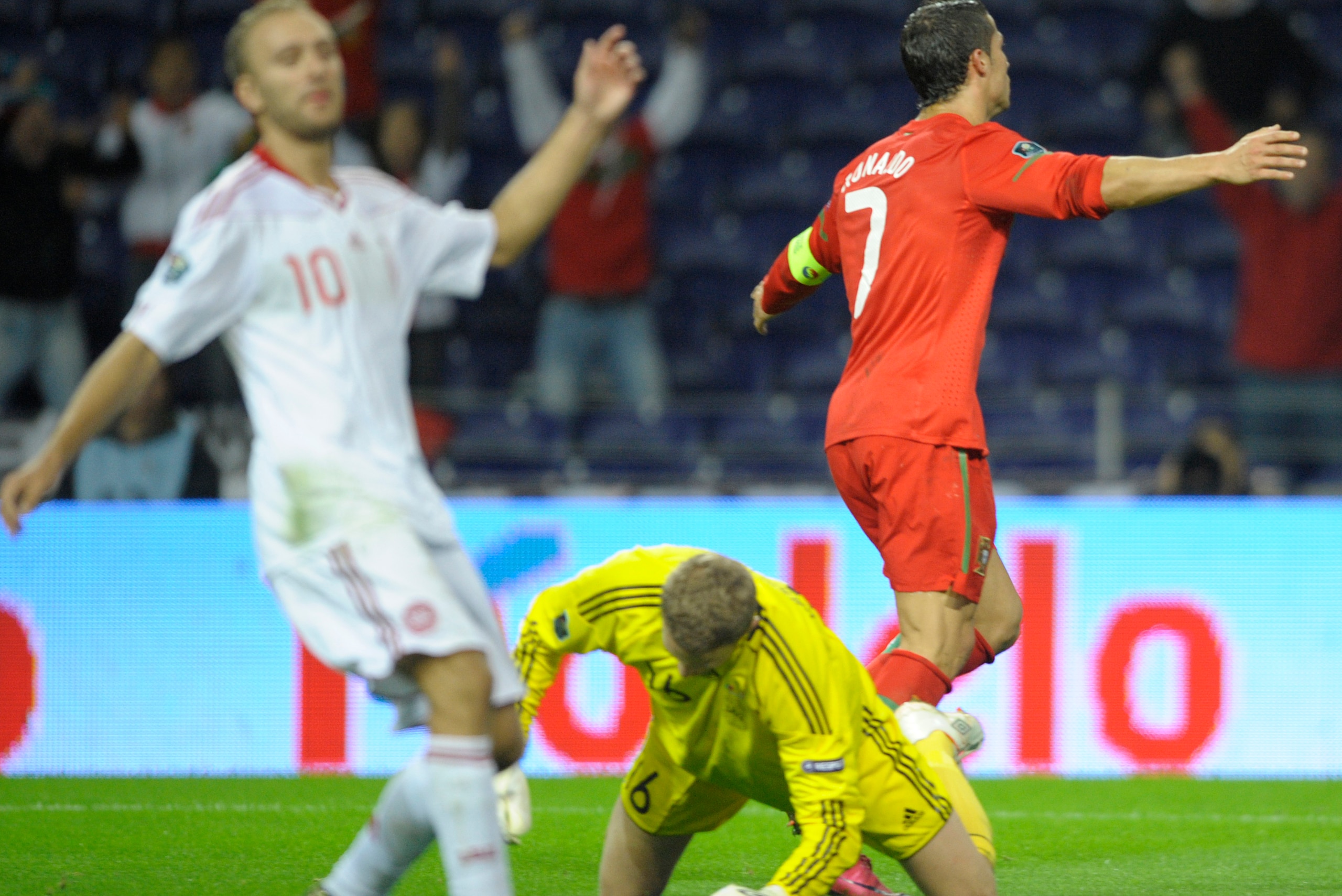 Portugal´s forward Cristiano Ronaldo (R) celebrates after scoring a goal against Denmark during their EURO 2012 qualifier football match at the Dragao Stadium in Porto, on October 8, 2010. Portugal won the match 3-1. AFP PHOTO/MIGUEL RIOPA (Photo credit s