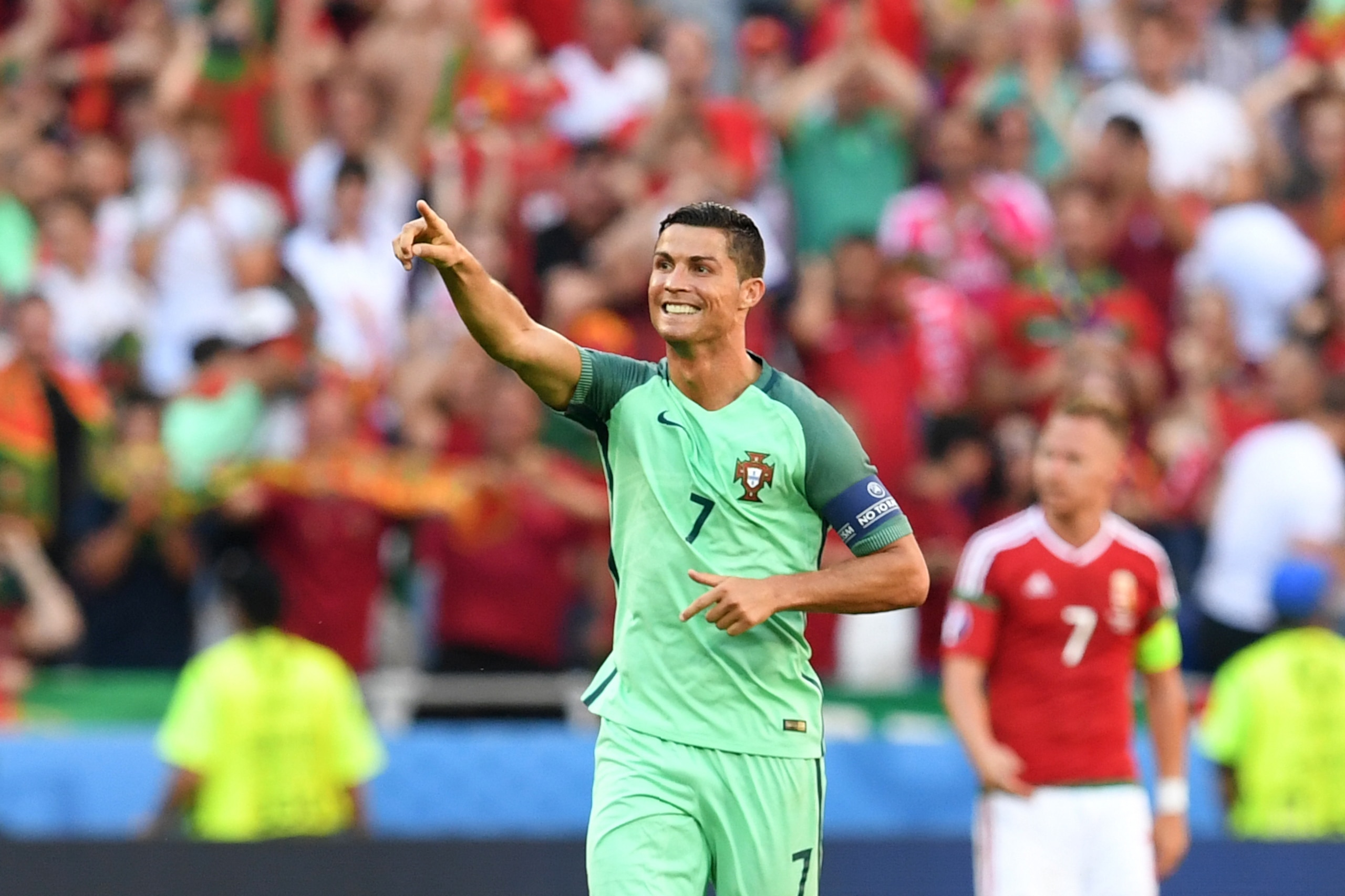 Portugal's forward Cristiano Ronaldo celebrates after scoring a goal during the Euro 2016 group F football match between Hungary and Portugal at the Parc Olympique Lyonnais stadium in Decines-Charpieu, near Lyon, on June 22, 2016. / AFP / FRANCISCO LEONG 