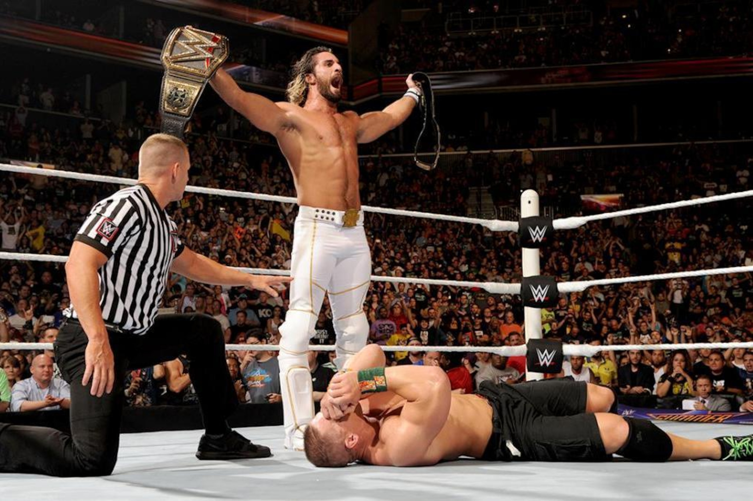 Seth Rollins celebrates his SummerSlam win over John Cena.