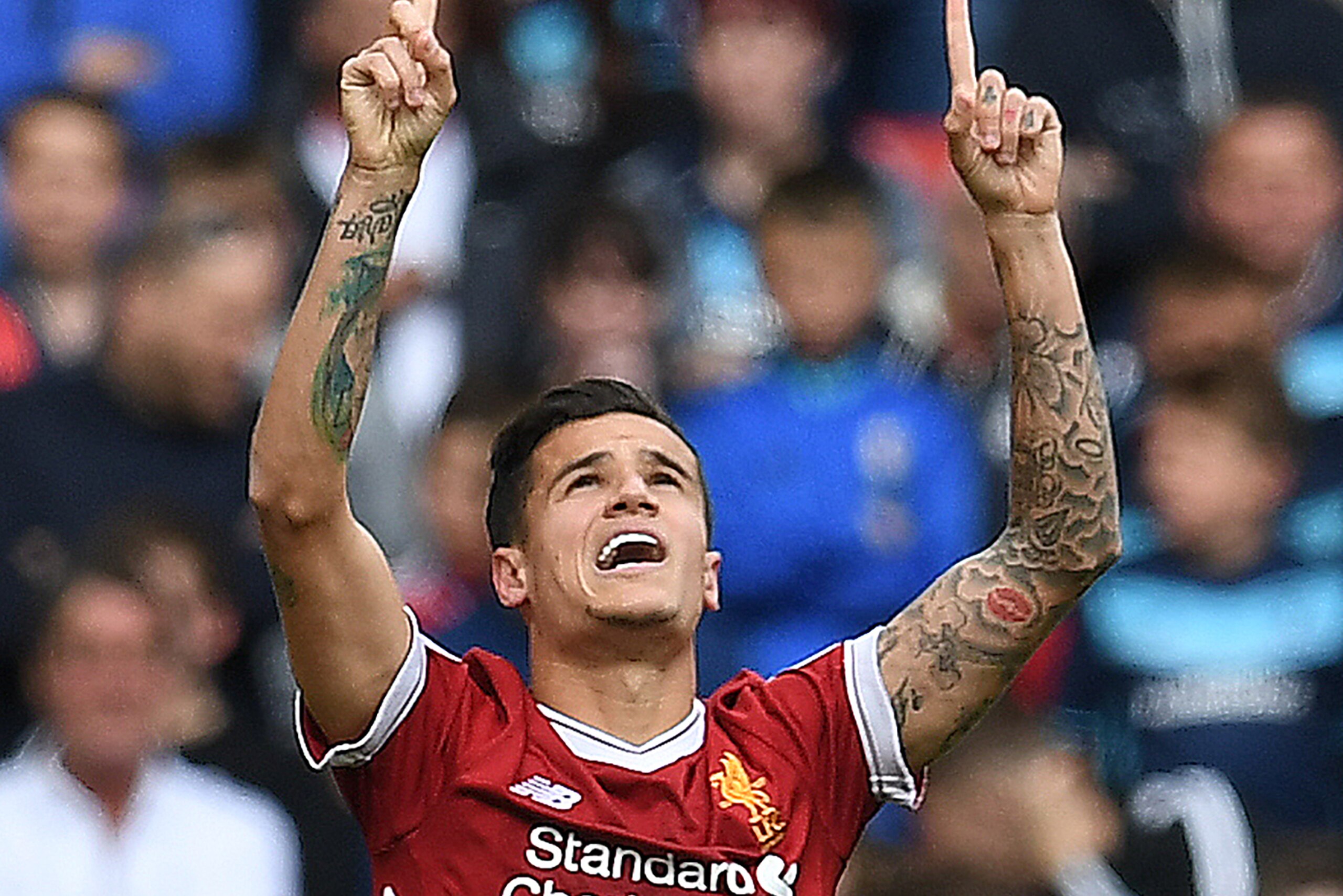 Liverpool's Brazilian midfielder Philippe Coutinho celebrates scoring his team's second goal during the English Premier League football match between Liverpool and Middlesbrough at Anfield in Liverpool, north west England on May 21, 2017. / AFP PHOTO / Pa