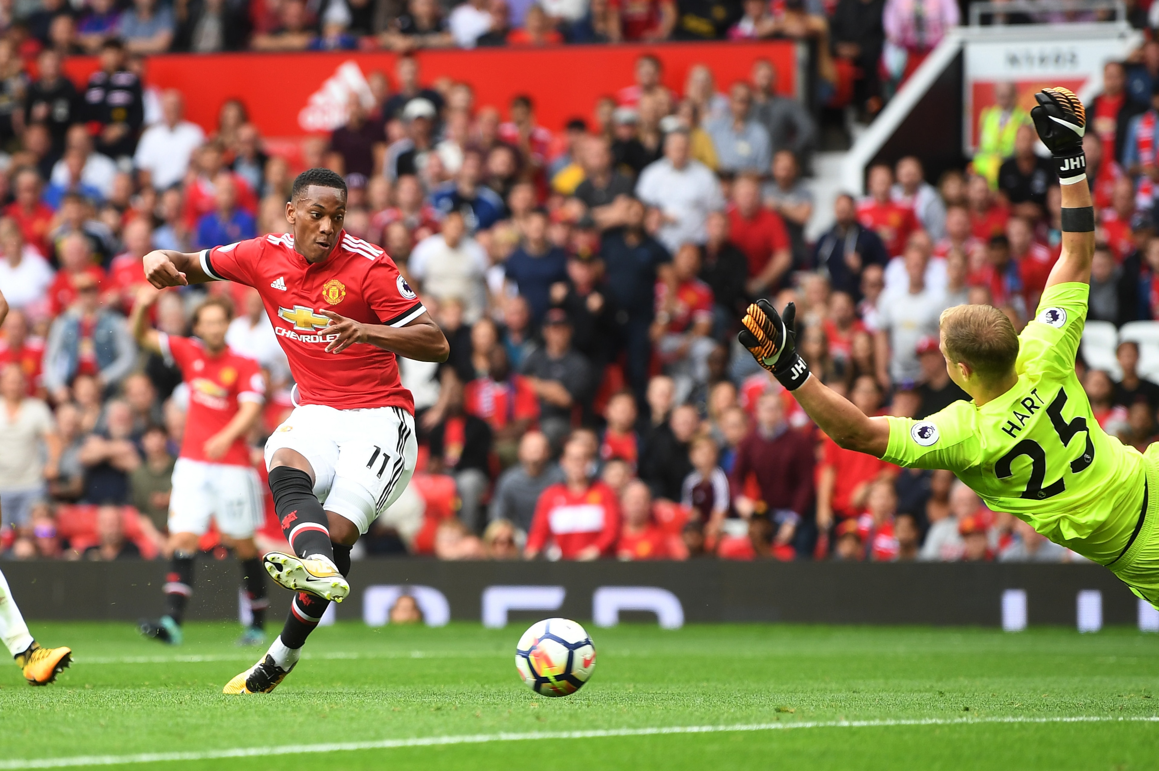 MANCHESTER, ENGLAND - AUGUST 13: Anthony Martial of Manchester United scores his sides third goal past Joe Hart of West Ham United during the Premier League match between Manchester United and West Ham United at Old Trafford on August 13, 2017 in Manchest MANCHESTER, ENGLAND - AUGUST 13: Anthony Martial of Manchester United scores his sides third goal past Joe Hart of West Ham United during the Premier League match between Manchester United and West Ham United at Old Trafford on August 13, 2017 in Manchest