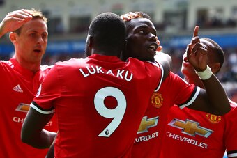 Manchester United's French midfielder Paul Pogba (R) celebrates with Manchester United's Belgian striker Romelu Lukaku (L) scoring the team's fourth goal during the English Premier League football match between Swansea City and Manchester United at The Li
