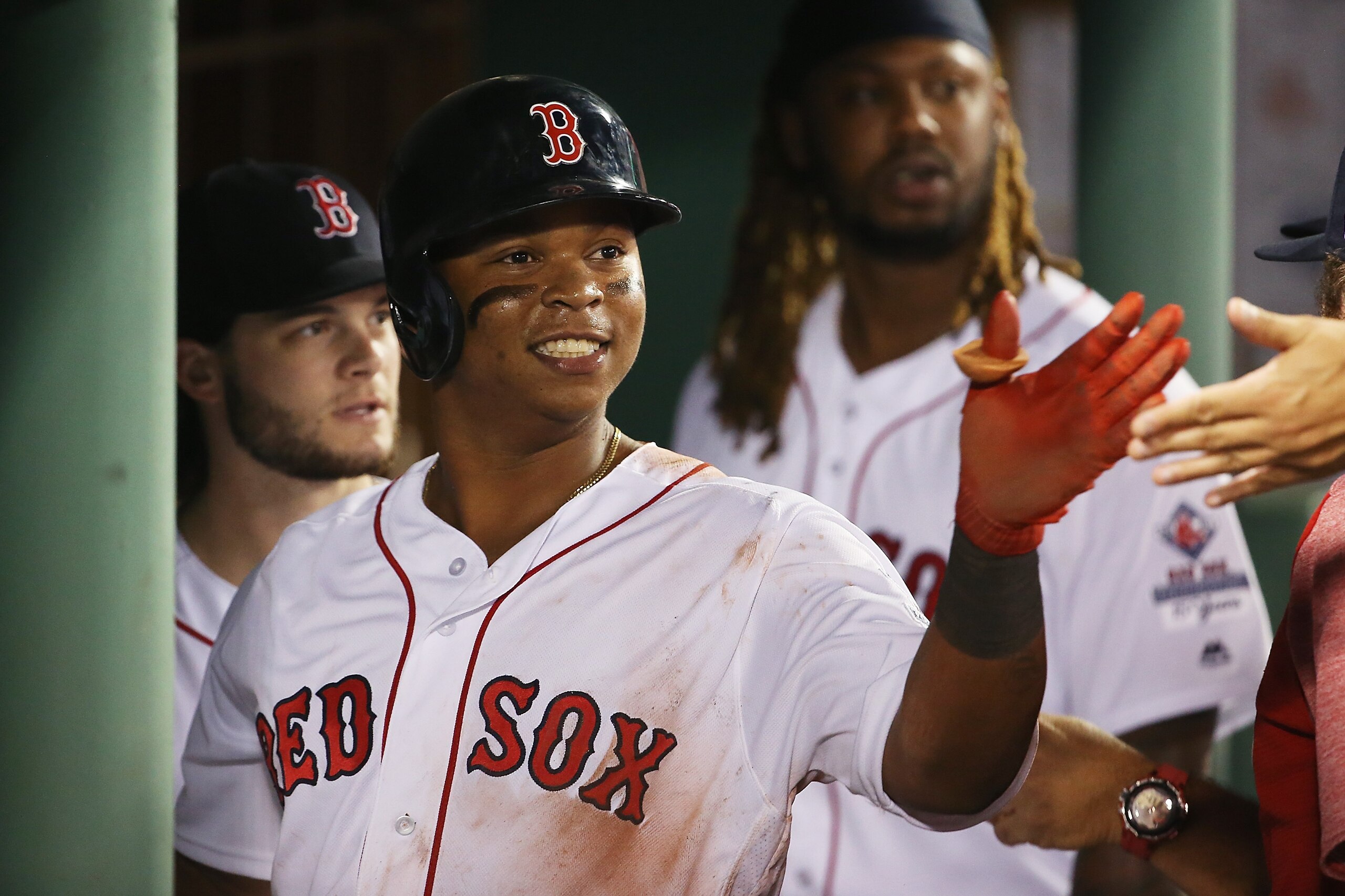 BOSTON, MA - AUGUST 19:  Rafael Devers #11 of the Boston Red Sox returns to the dugout after he scores in the fifth inning of a game against the New York Yankees at Fenway Park on August 19, 2017 in Boston, Massachusetts.  (Photo by Adam Glanzman/Getty Im