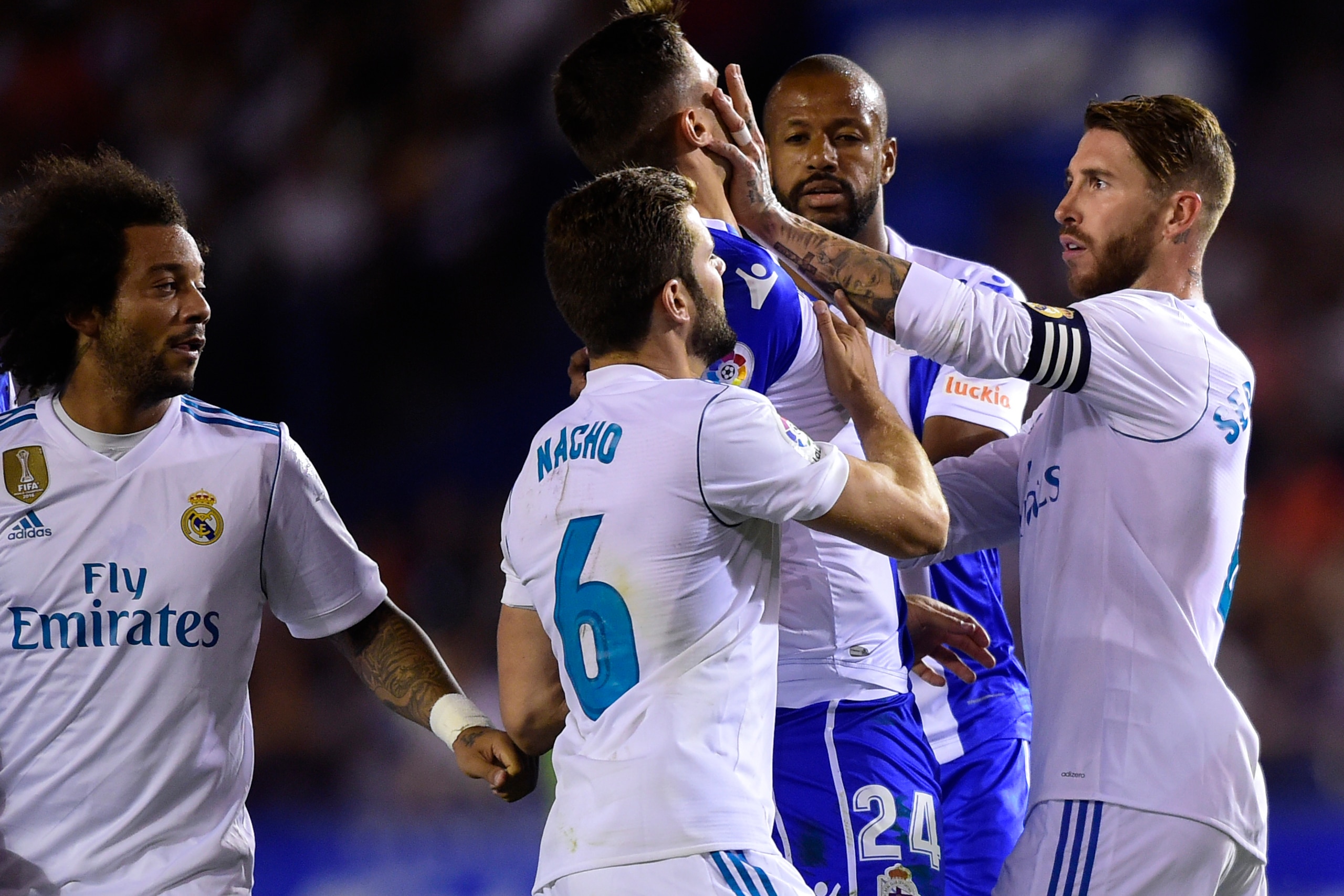 Real Madrid's defender Sergio Ramos (R) clashes with Deportivo La Coruna's Swiss defender Fabian Schar during the Spanish league footbal match RC Deportivo de la Coruna vs Real Madrid CF at the Municipal de Riazor stadium in La Coruna on August 20, 2017. 