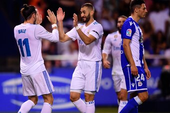 Real Madrid's Welsh forward Gareth Bale (L) celebrates with teammate French forward Karim Benzema after scoring a goal during the Spanish league footbal match RC Deportivo de la Coruna vs Real Madrid CF at the Municipal de Riazor stadium in La Coruna on A