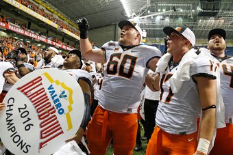 SAN ANTONIO,TX - DECEMBER 29: Oklahoma State Cowboys celebrate their victory over the Colorado Buffaloes in the Valero Alamo Bowl at the Alamodome on December 29, 2016 in San Antonio, Texas.  (Photo by Ronald Cortes/Getty Images)