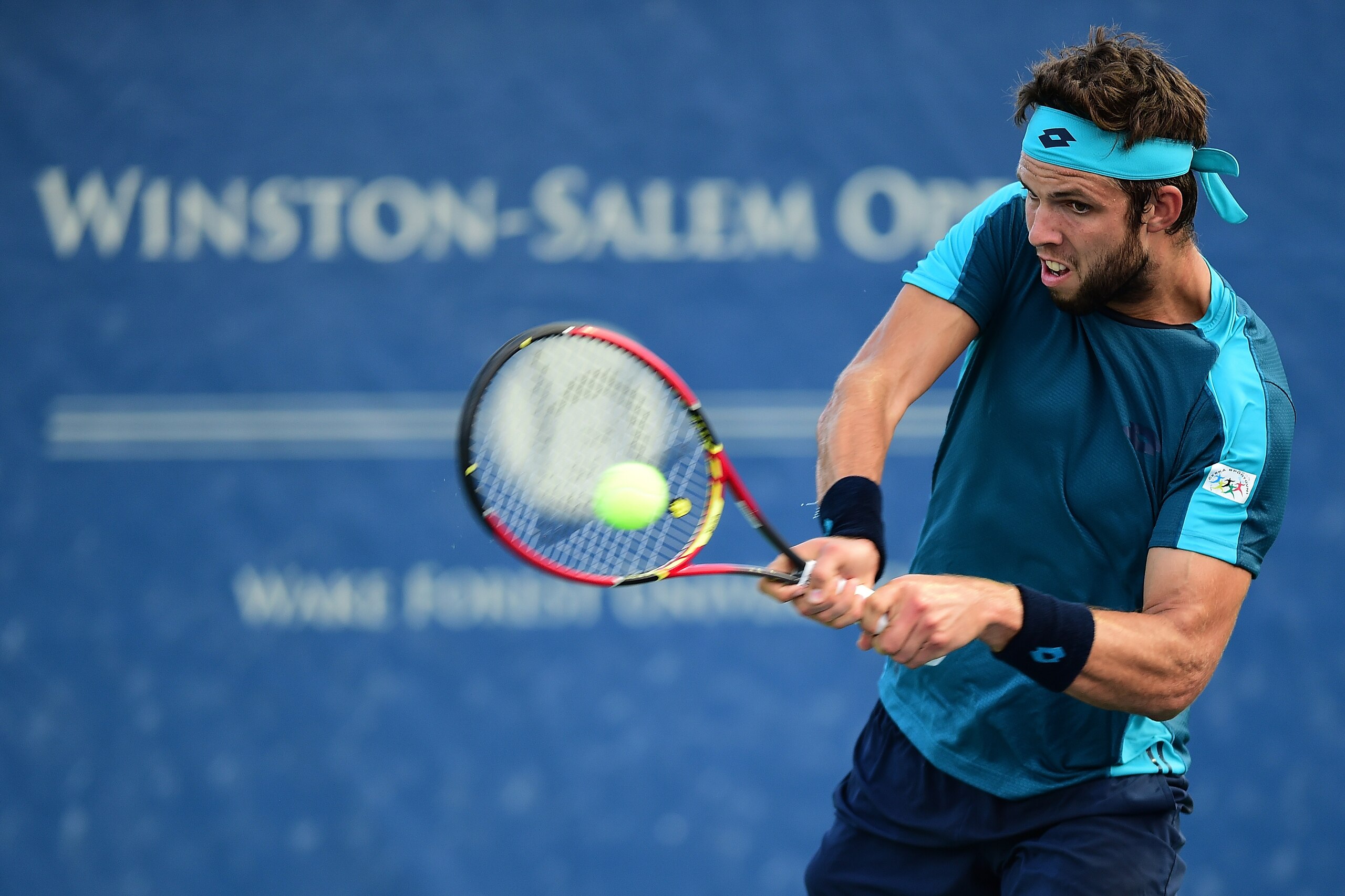 WINSTON SALEM, NC - AUGUST 21:  Jiri Vesely of Czech Republic returns a shot from Marcos Baghdatis of Cyprus during the third day of the Winston-Salem Open at Wake Forest University on August 21, 2017 in Winston Salem, North Carolina.  (Photo by Jared C. 