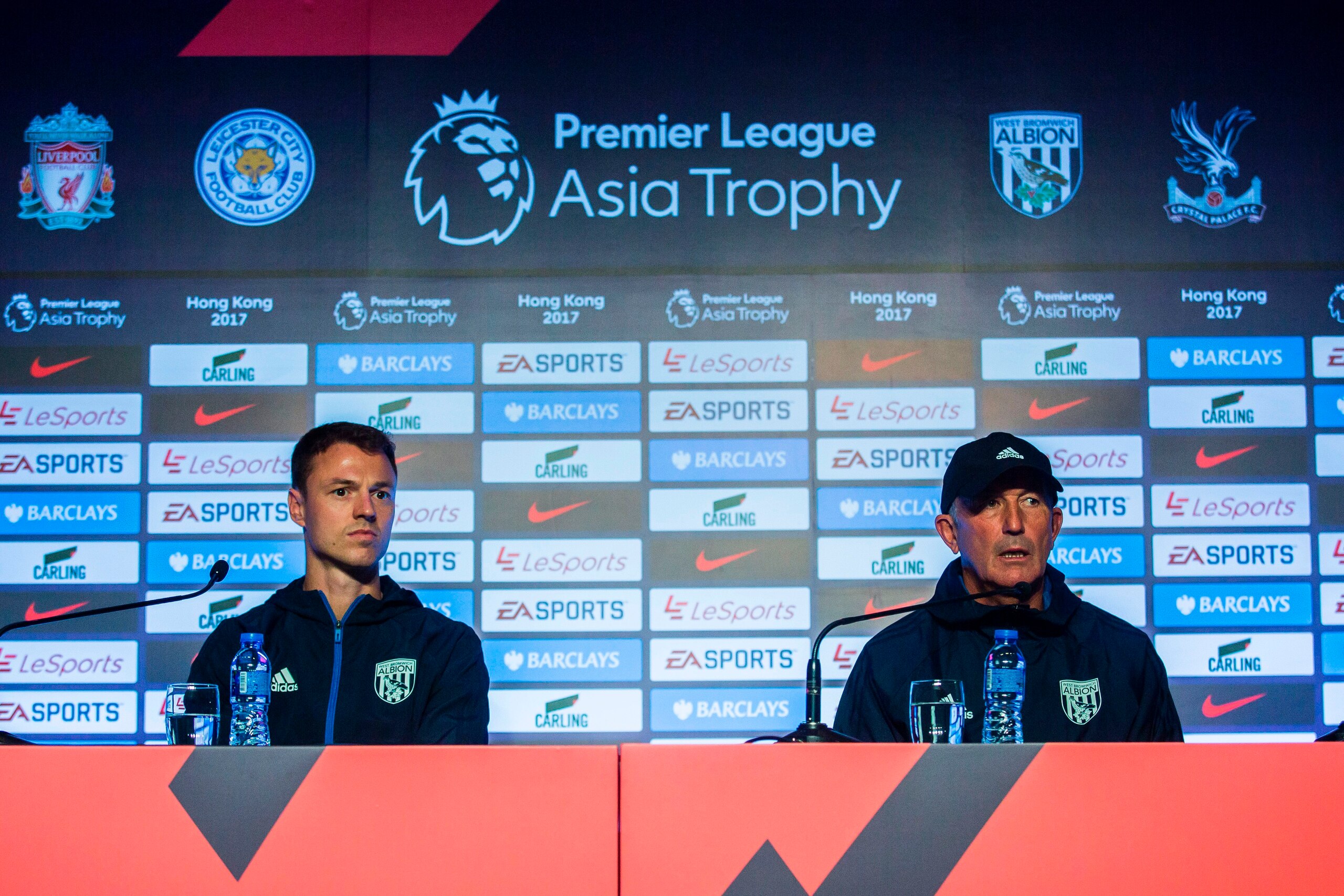 West Bromwich Albion Football Club manager Tony Pulis (R) and player Jonny Evans (L) attend a press conference in Hong Kong on July 18, 2017, ahead of the 2017 Premier League Asia Trophy being played on July 19 and 22. / AFP PHOTO / ISAAC LAWRENCE        