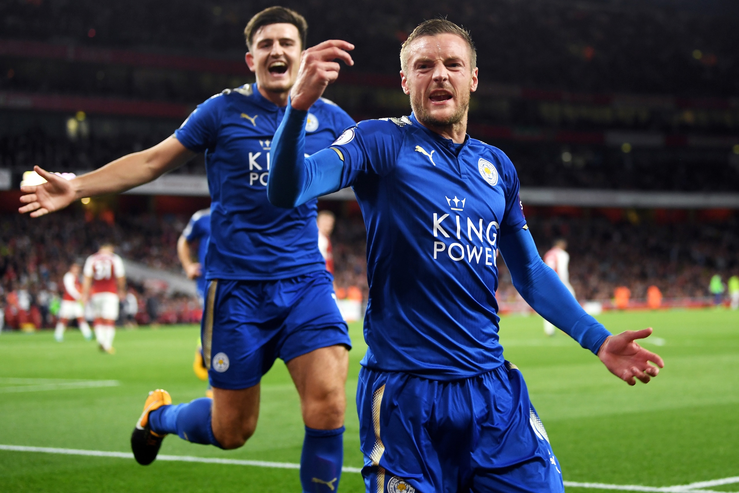 LONDON, ENGLAND - AUGUST 11:  Jamie Vardy (R) of Leicester City is congratulated by teammate Harry Maguire (L) after scoring his team's third goal during the Premier League match between Arsenal and Leicester City at the Emirates Stadium on August 11, 201