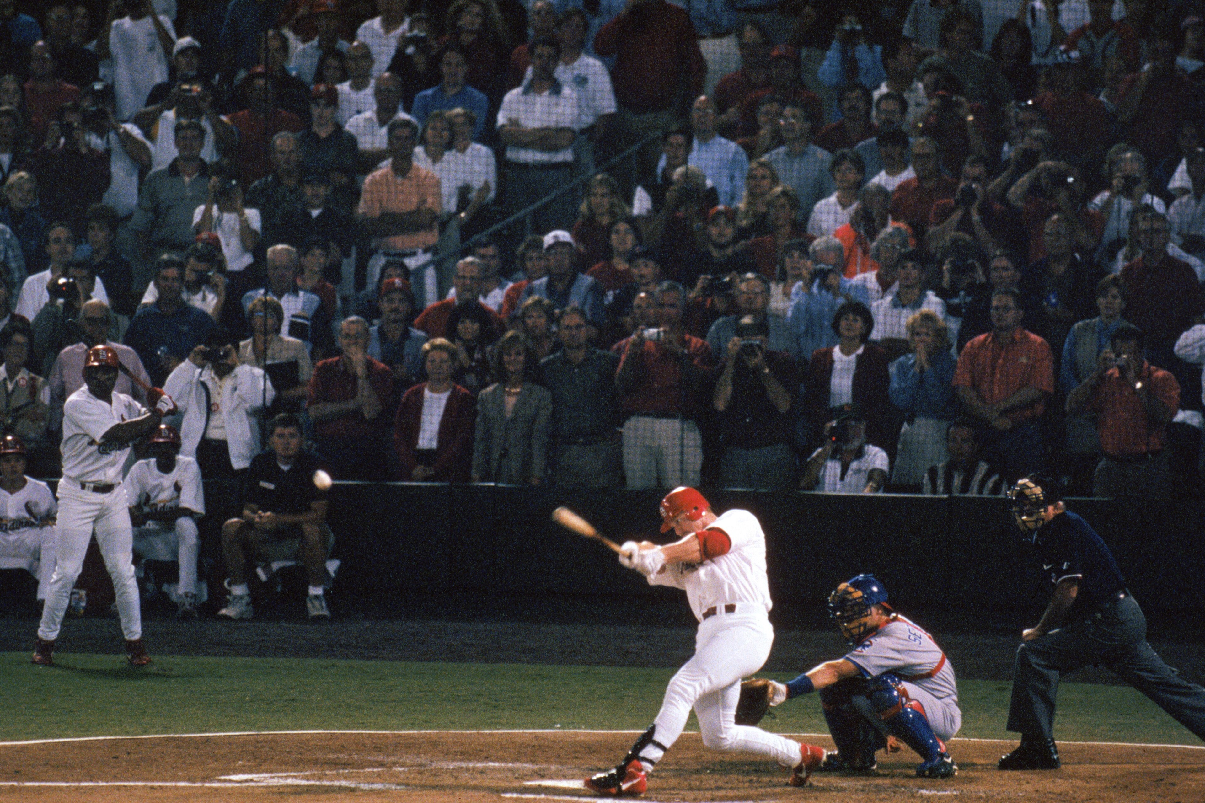 ST. LOUIS - SEPTEMBER 8:  Mark McGwire #25 of the St. Louis Cardinals hits a 341- feet line drive over the left field wall, for his 62nd home run of the year surpassing the 37-year mark held by Roger Maris for the single season home run leader during the 
