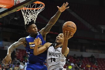 LAS VEGAS, NV - JULY 12:  C.J. Williams #14 of the Minnesota Timberwolves drives to the basket against Jordan Bell #2 of the Golden State Warriors during the 2017 Summer League at the Thomas & Mack Center on July 12, 2017 in Las Vegas, Nevada. Golden Stat