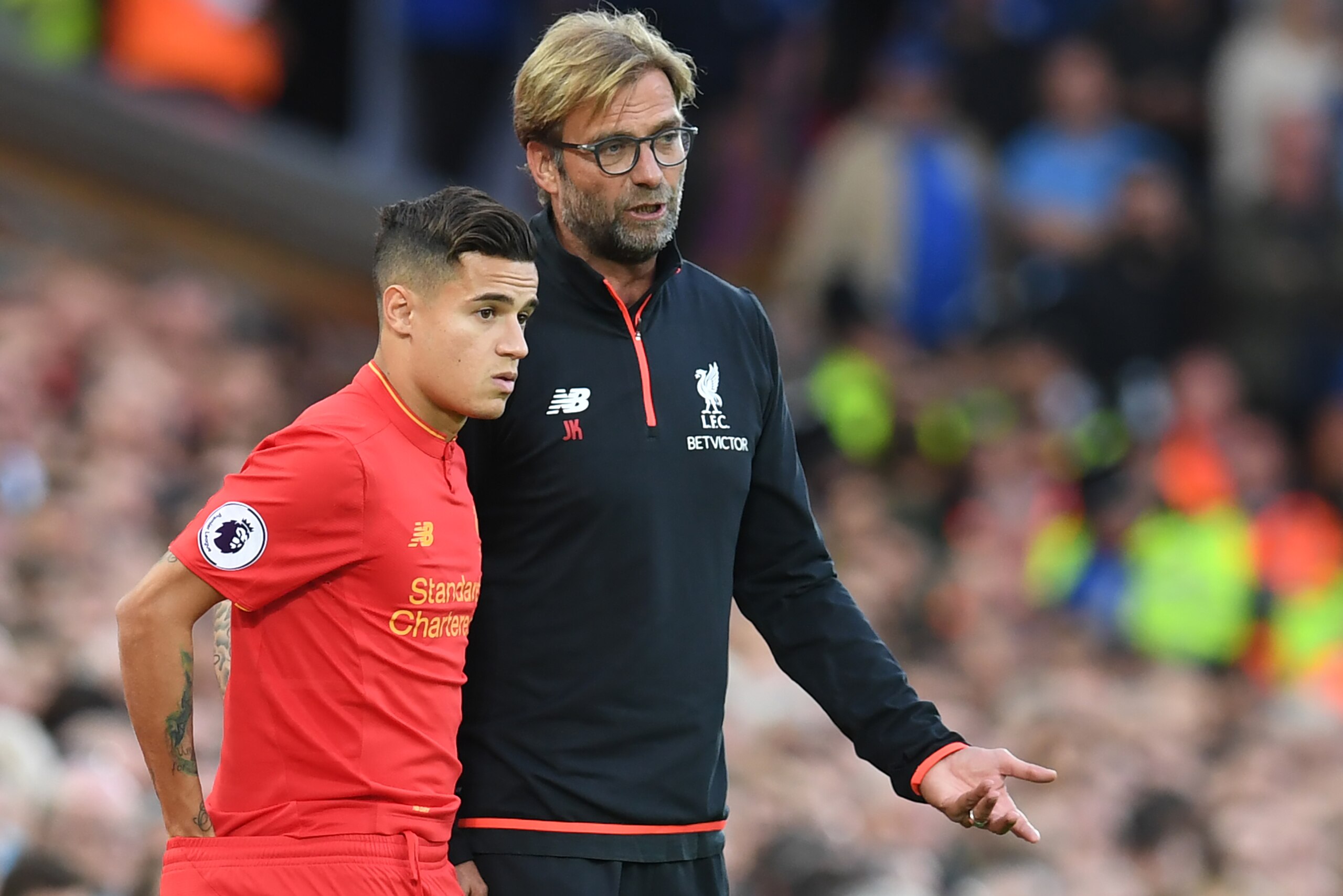 Liverpool's German manager Jurgen Klopp (R) speaks to Liverpool's Brazilian midfielder Philippe Coutinho on the touchline during the English Premier League football match between Liverpool and Leicester City at Anfield in Liverpool, north west England on 