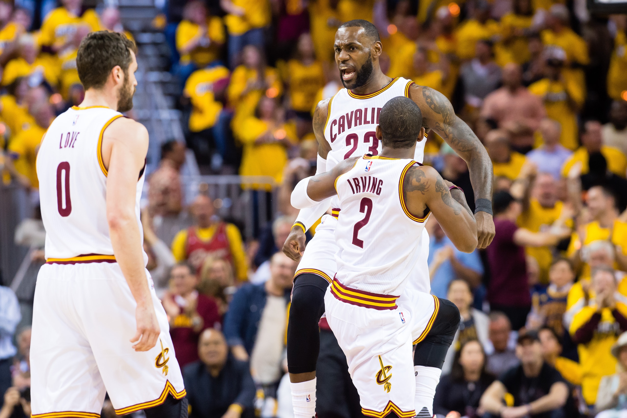 CLEVELAND, OH - MAY 1: LeBron James #23 celebrates with Kyrie Irving #2 and Kevin Love #0 of the Cleveland Cavaliers after scoring during the first half of Game One of the NBA Eastern Conference semifinals against the Toronto Raptors at Quicken Loans Aren