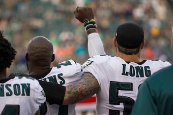 PHILADELPHIA, PA - AUGUST 17: Malcolm Jenkins #27 of the Philadelphia Eagles holds his fist in the air during the national anthem while Chris Long #56 of the Philadelphia Eagles puts his arm around him prior to the preseason game against the Buffalo Bills
