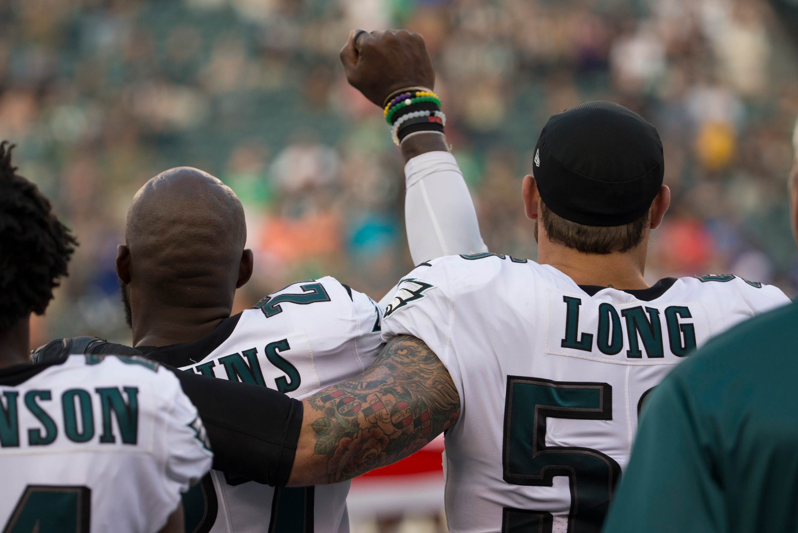 PHILADELPHIA, PA - AUGUST 17: Malcolm Jenkins #27 of the Philadelphia Eagles holds his fist in the air during the national anthem while Chris Long #56 of the Philadelphia Eagles puts his arm around him prior to the preseason game against the Buffalo Bills
