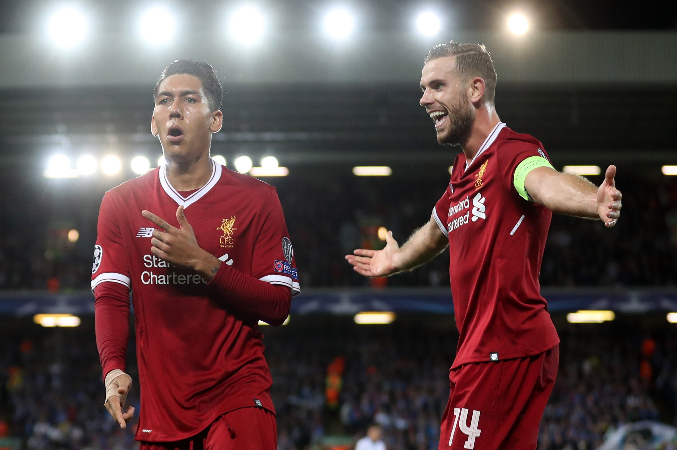 LIVERPOOL, ENGLAND - AUGUST 23:  Roberto Firmino of Liverpool celebrates scoring his sides fourth goal with Jordan Henderson of Liverpool during the UEFA Champions League Qualifying Play-Offs round second leg match between Liverpool FC and 1899 Hoffenheim
