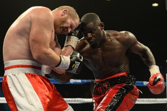 Sep 13, 2014; Las Vegas, NV, USA;  Andrew Tabiti (red gloves)  and Caleb Grummet (black gloves) during their Cruiserweight fight at the MGM Garden Arena. Mandatory Credit: Jayne Kamin-Oncea-USA TODAY Sports