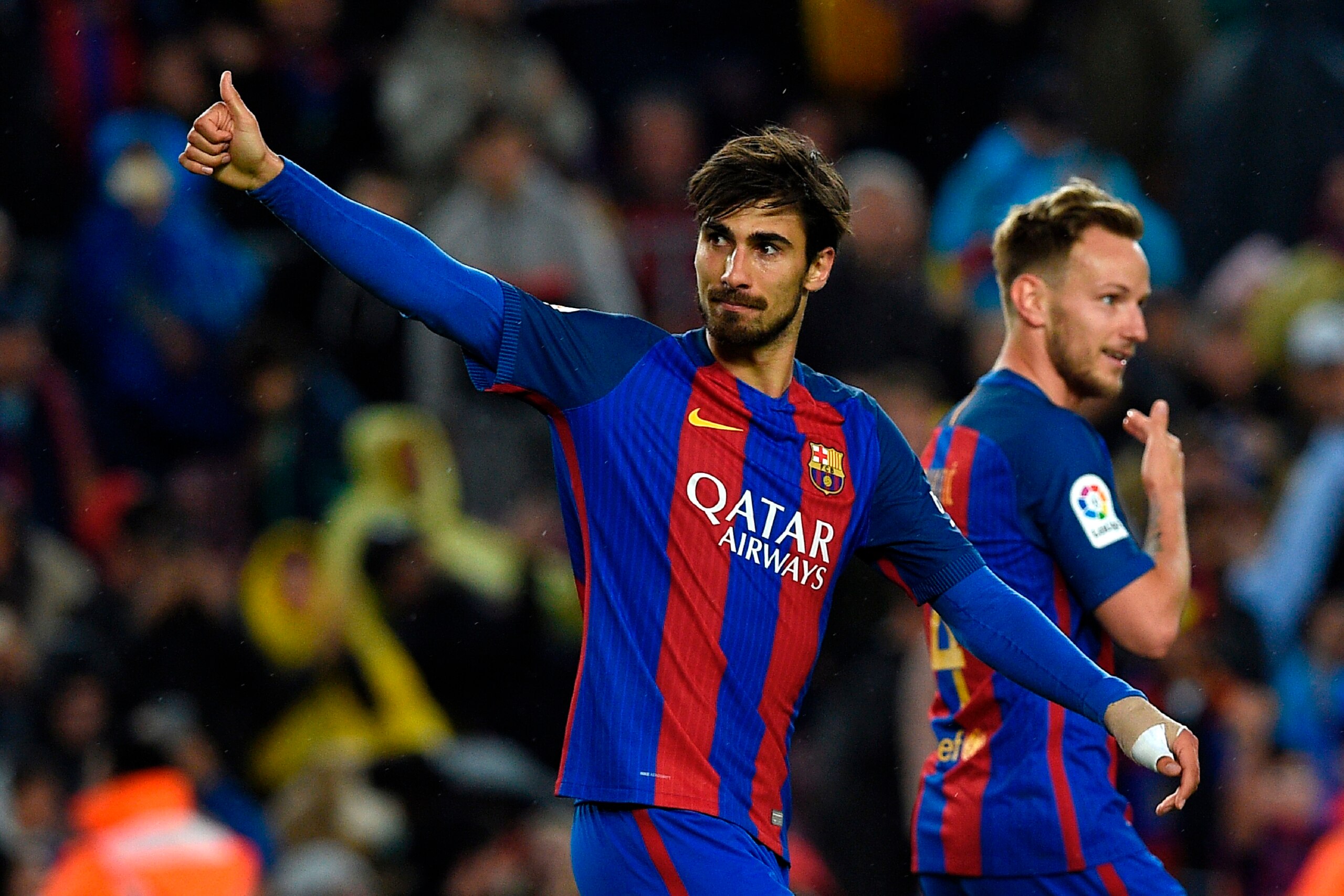 Barcelona's Portuguese midfielder Andre Gomes (L) celebrates after scoring a goal during the Spanish league football match FC Barcelona vs CA Osasuna at the Camp Nou stadium in Barcelona on April 26, 2017. / AFP PHOTO / LLUIS GENE        (Photo credit sho