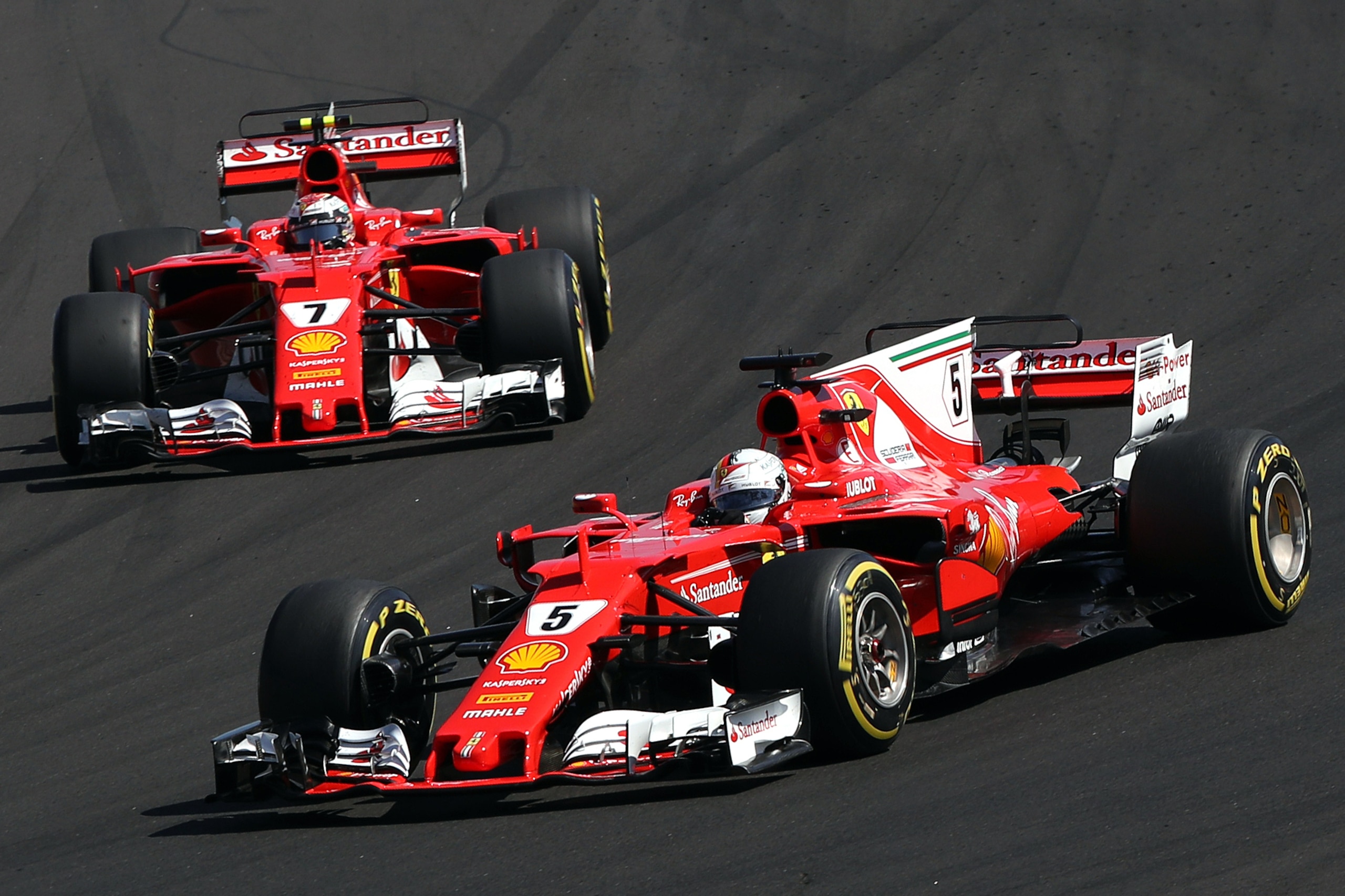 Ferrari's German driver Sebastian Vettel (front) and Ferrari's Finnish driver Kimi Raikkonen (Back) race at the Hungaroring circuit in Budapest on July 30, 2017, during the Formula One Hungarian Grand Prix. / AFP PHOTO / Peter Kohalmi        (Photo credit