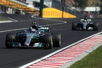 Mercedes' Finnish driver Valtteri Bottas (Front) and Mercedes' British driver Lewis Hamilton    (Back) race at the Hungaroring circuit in Budapest on July 30, 2017, during the Formula One Hungarian Grand Prix. / AFP PHOTO / Peter Kohalmi        (Photo cre