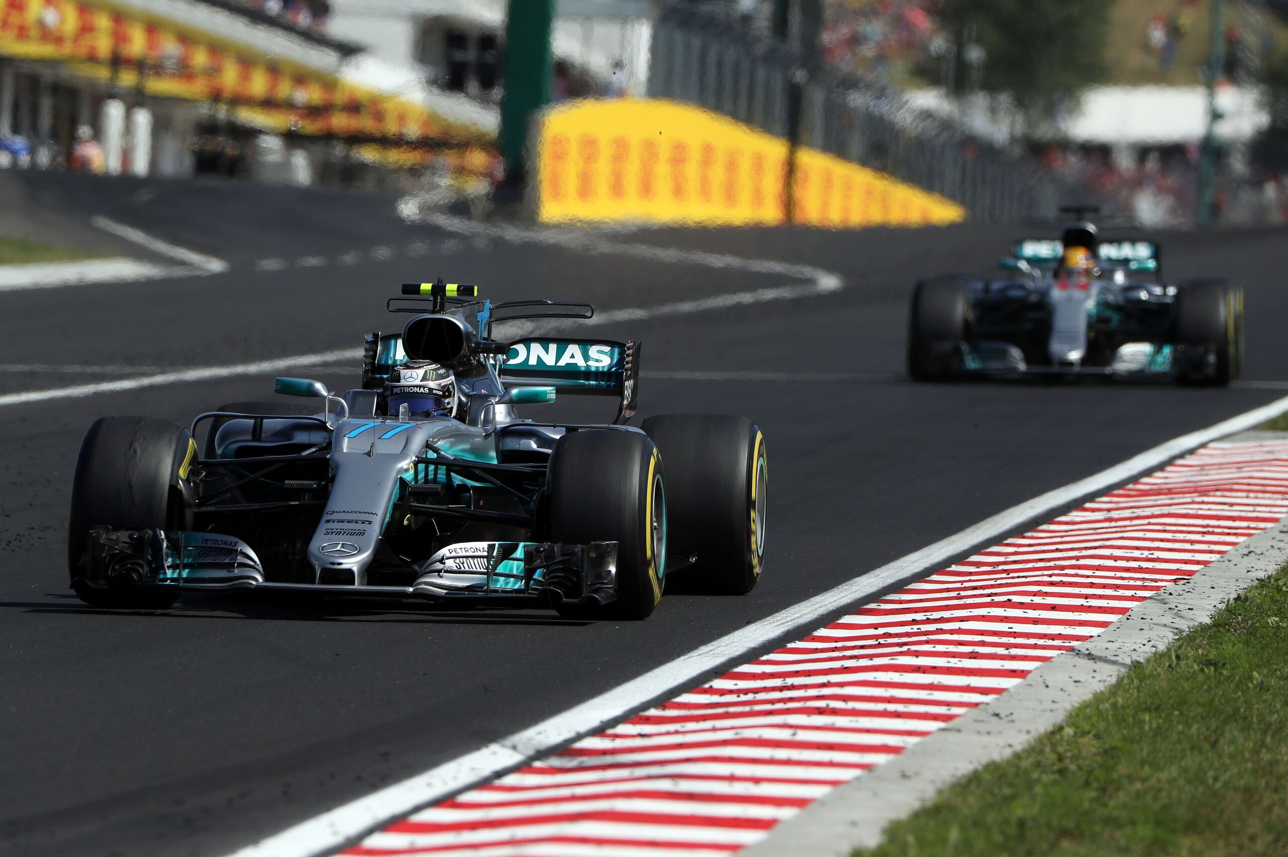 Mercedes' Finnish driver Valtteri Bottas (Front) and Mercedes' British driver Lewis Hamilton    (Back) race at the Hungaroring circuit in Budapest on July 30, 2017, during the Formula One Hungarian Grand Prix. / AFP PHOTO / Peter Kohalmi        (Photo cre