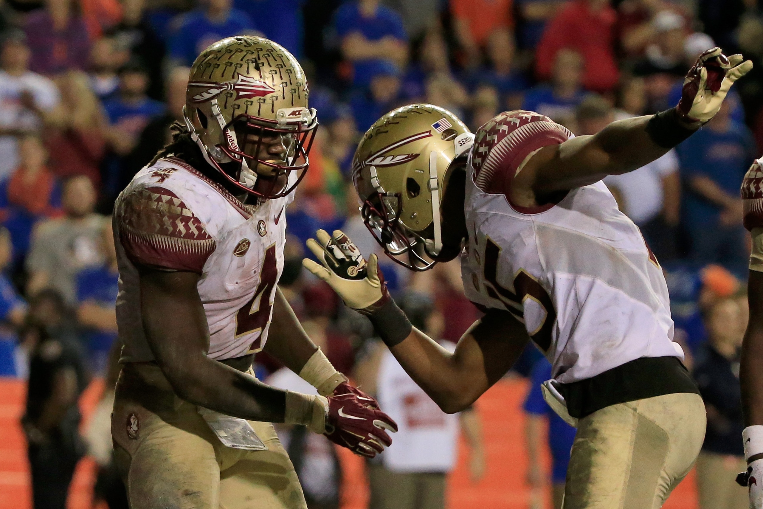 GAINESVILLE, FL - NOVEMBER 28:  Dalvin Cook #4 and Travis Rudolph #15 of the Florida State celebrate a touchdown during the game against the Florida Gators at Ben Hill Griffin Stadium on November 28, 2015 in Gainesville, Florida.  (Photo by Sam Greenwood/