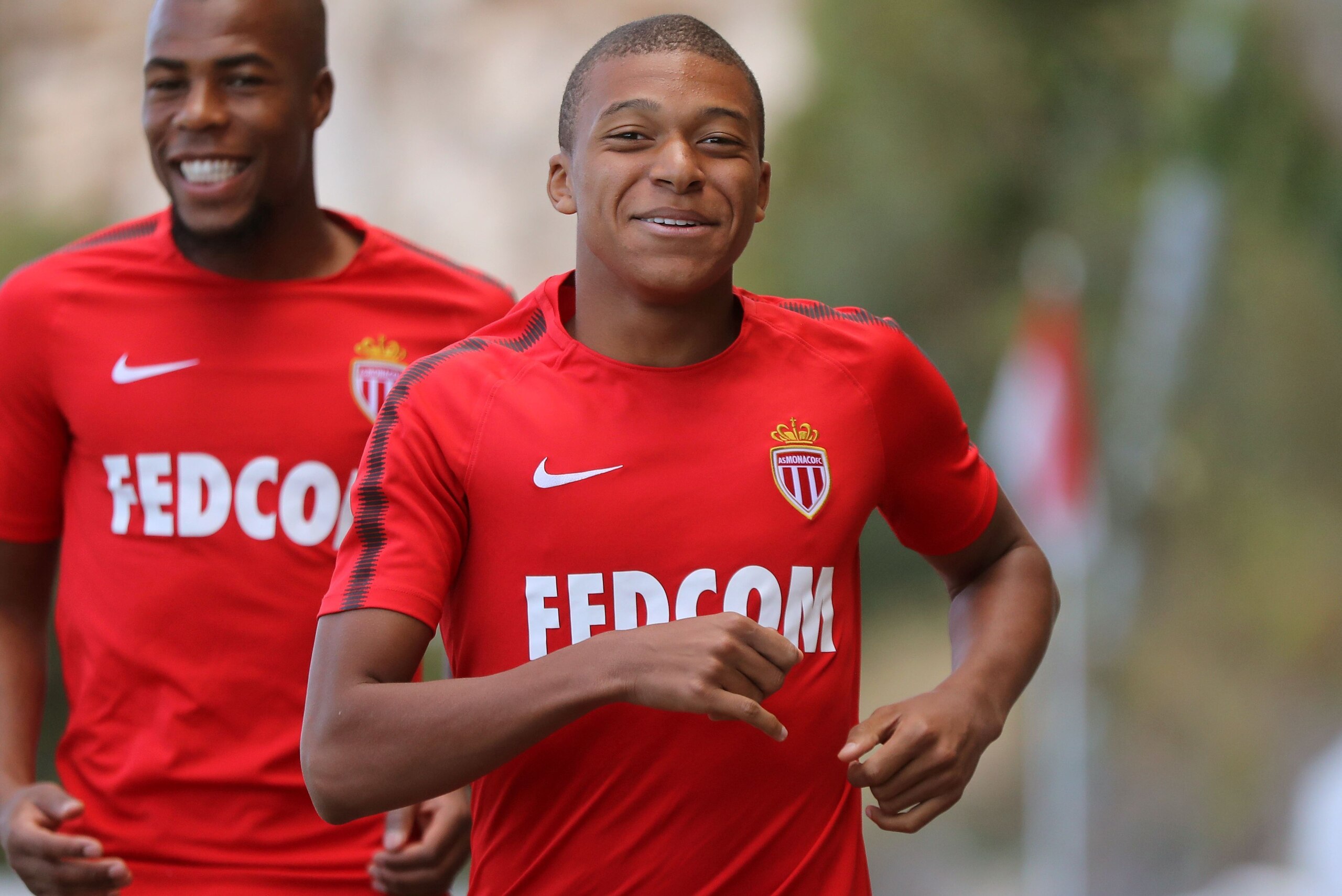 Monaco L1 football club's forward Kylian Mbappe Lottin (R) and defender Djibril Sidibe (L) arrive for a training session on August 11, 2017 in La Turbie, near Monaco.   / AFP PHOTO / VALERY HACHE        (Photo credit should read VALERY HACHE/AFP/Getty Ima