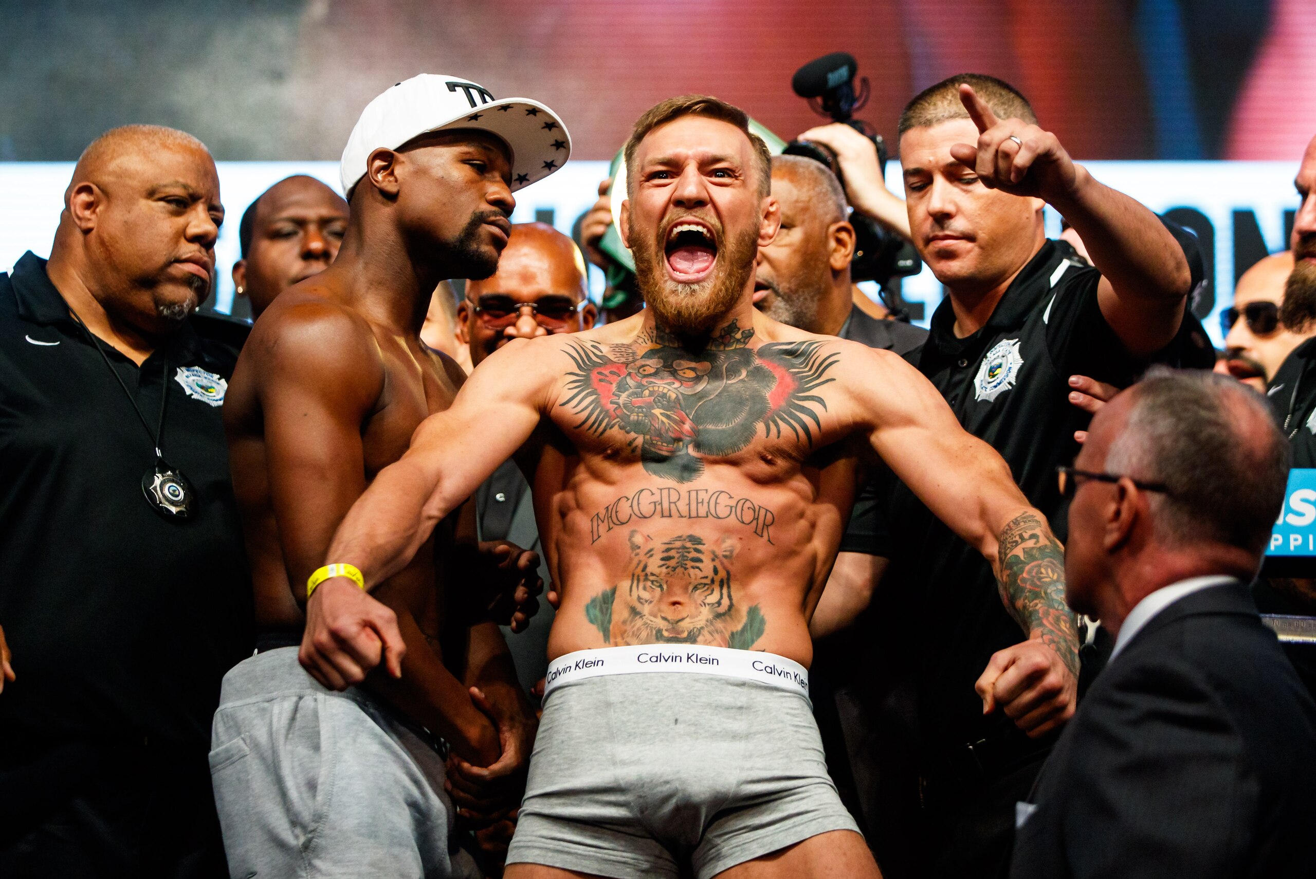 Aug 25, 2017; Las Vegas, NV, USA;  Conor McGregor (right) reacts alongside Floyd Mayweather during weigh ins for the upcoming boxing match at T-Mobile Arena. Mandatory Credit: Mark J. Rebilas-USA TODAY Sports