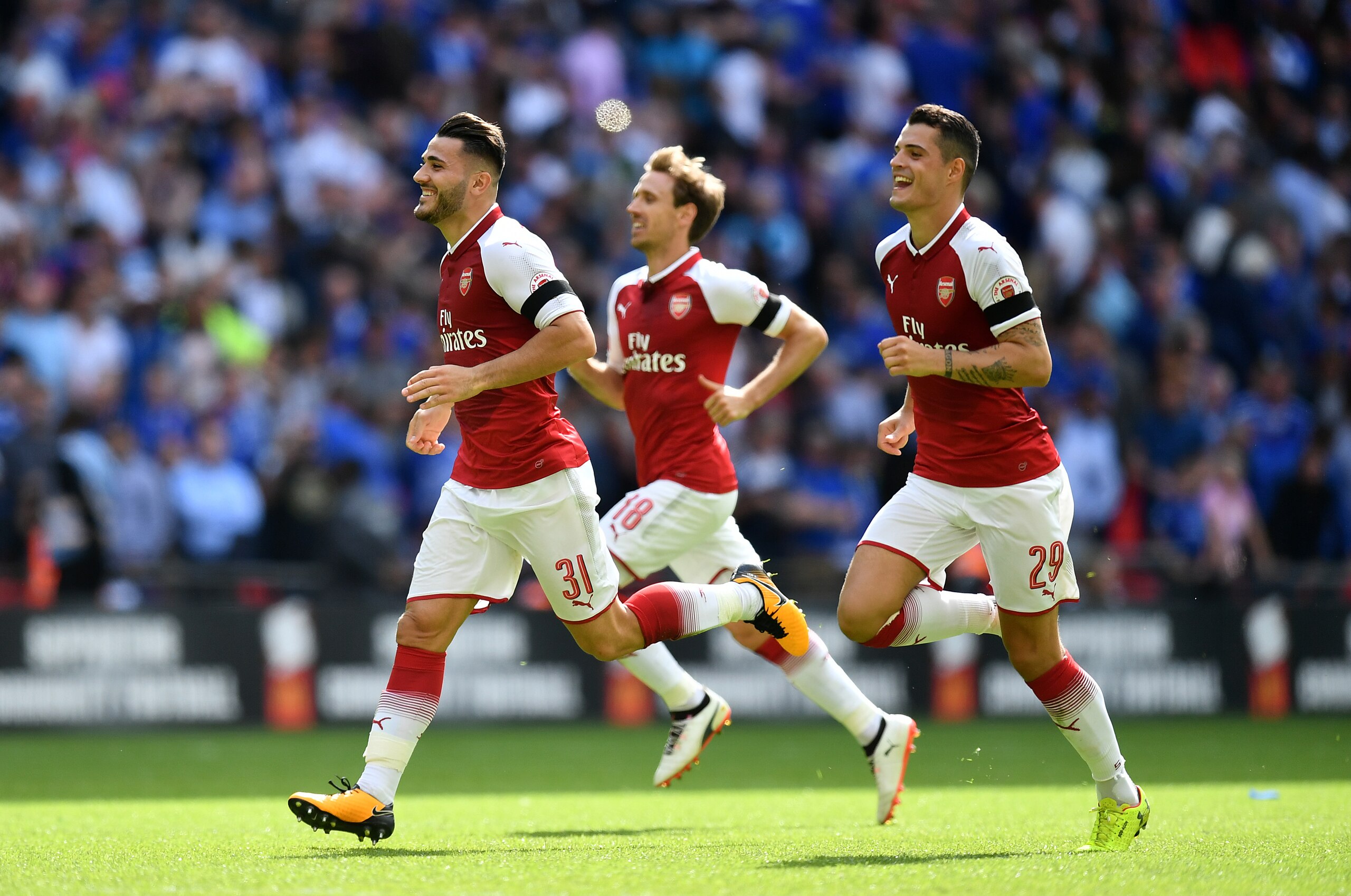 LONDON, ENGLAND - AUGUST 06:  Sead Kolasinac, Nacho Monreal and Granit Xhaka of Arsenal celebrate victory during the FA Community Shield between Chelsea and Arsenal at Wembley Stadium on August 6, 2017 in London, England. (Photo by Dan Mullan/Getty Images