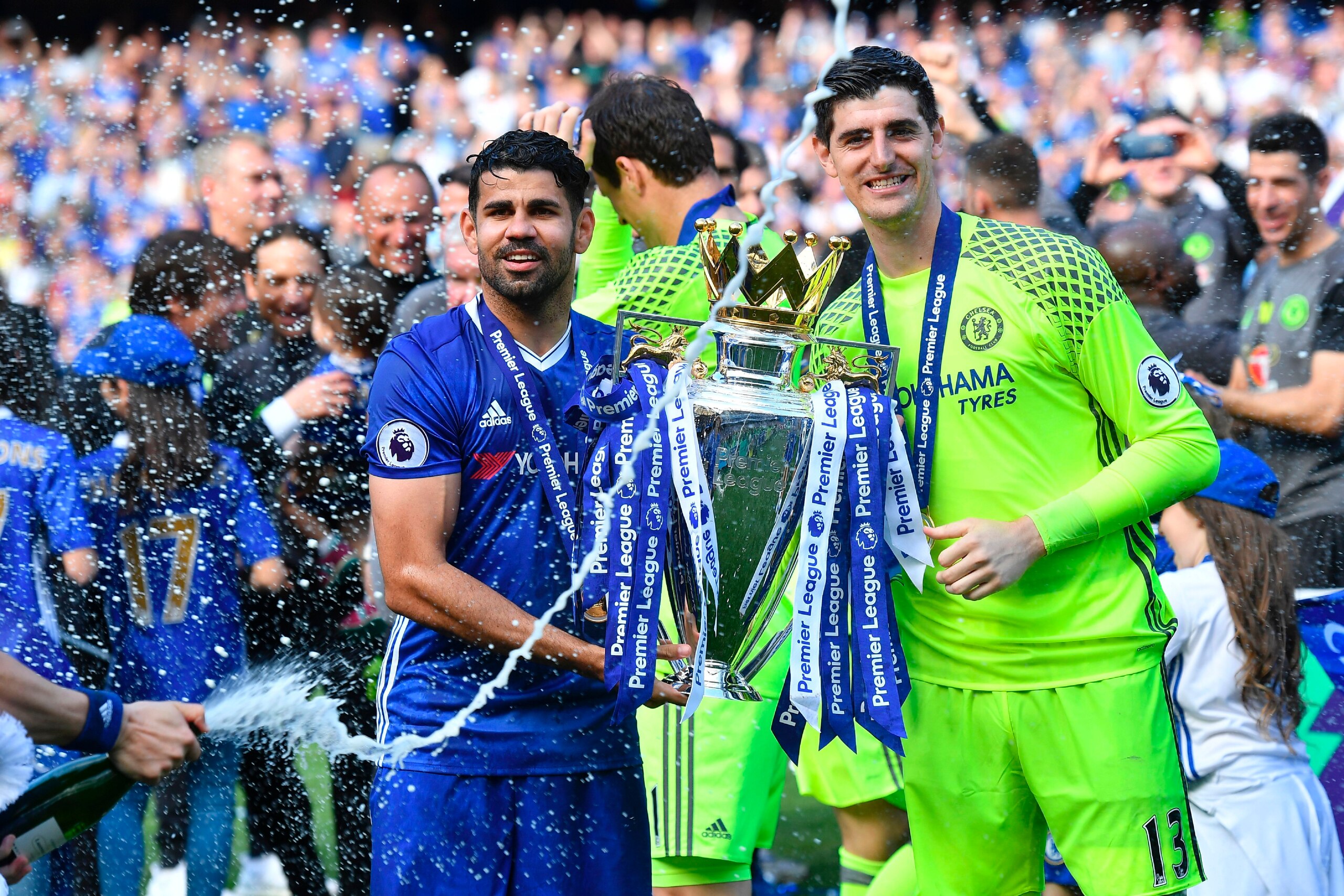 Chelsea's Brazilian-born Spanish striker Diego Costa (L) and Chelsea's Belgian goalkeeper Thibaut Courtois hold the English Premier League trophy, as players celebrate their league title win at the end of the Premier League football match between Chelsea 