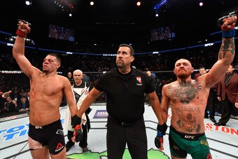 LAS VEGAS, NV - AUGUST 20:   (R-L) Conor McGregor of Ireland and Nate Diaz raise their hands and wait to hear the judges decision after their welterweight bout during the UFC 202 event at T-Mobile Arena on August 20, 2016 in Las Vegas, Nevada. (Photo by J