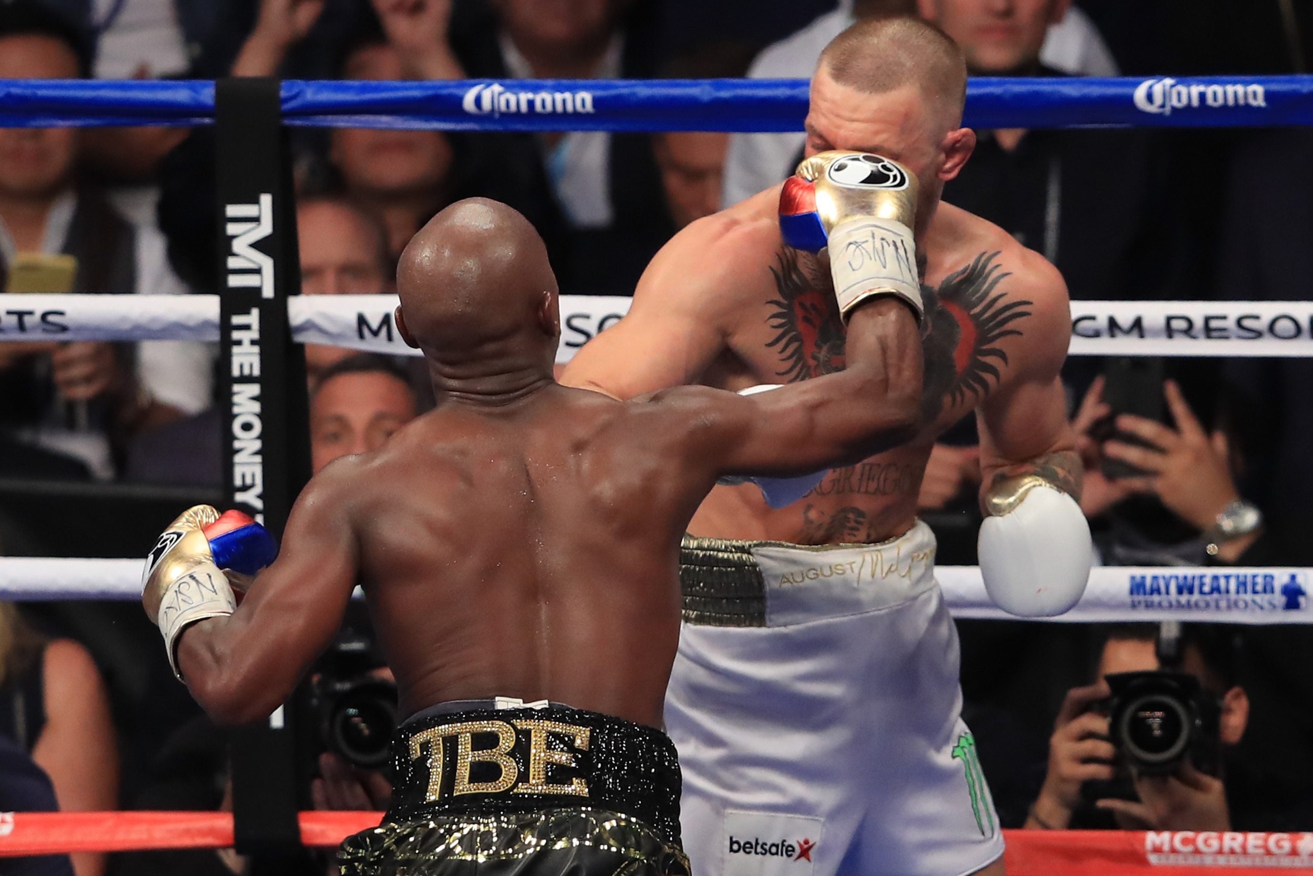LAS VEGAS, NV - AUGUST 26:  (L-R) Floyd Mayweather Jr. throws a punch at Conor McGregor during their super welterweight boxing match on August 26, 2017 at T-Mobile Arena in Las Vegas, Nevada.  (Photo by Sean M. Haffey/Getty Images)