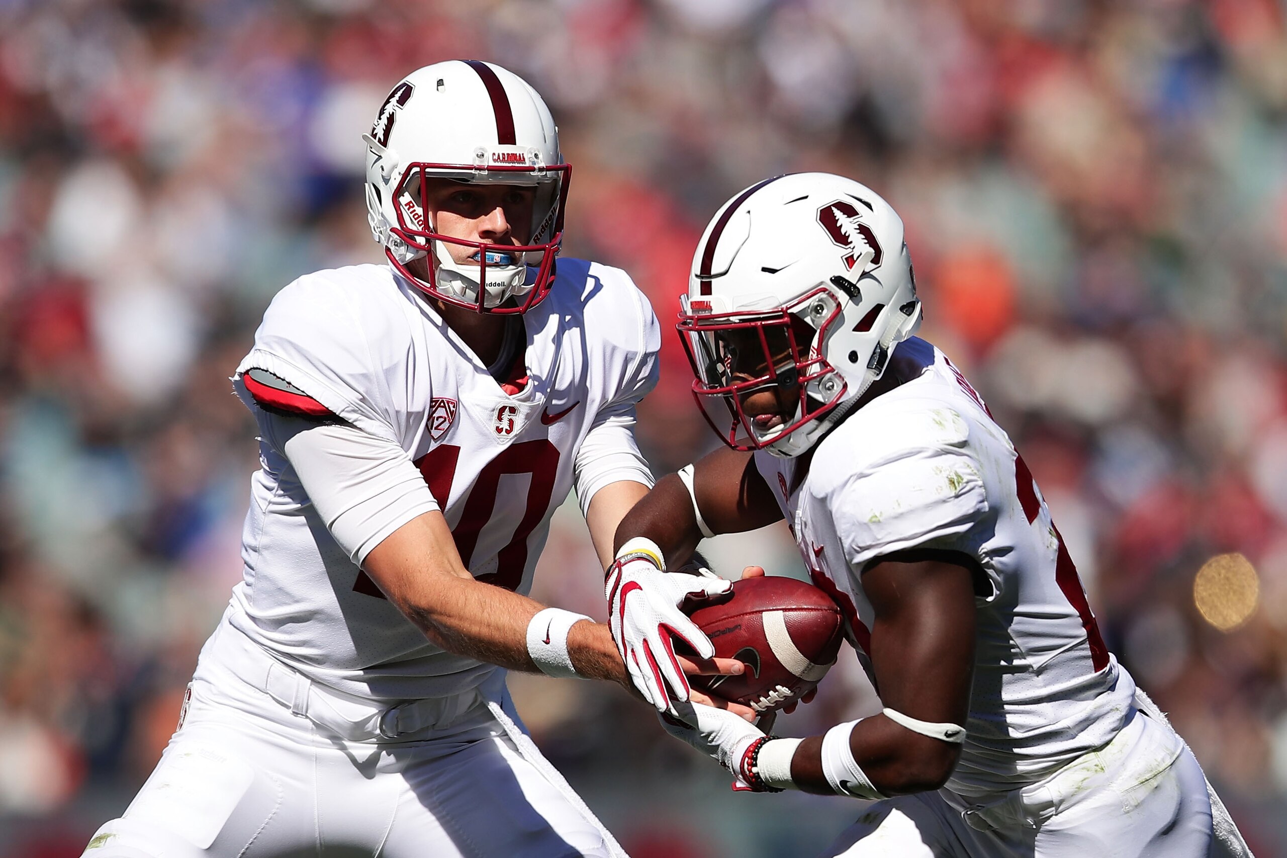 SYDNEY, AUSTRALIA - AUGUST 27:  Keller Chryst of Stanford hands the ball off to Bryce Love of Stanford on the way to scoring a touchdown during the College Football Sydney Cup match between Stanford University (Stanford Cardinal) and Rice University (Rice