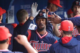 TORONTO, ON - AUGUST 25: Byron Buxton #25 of the Minnesota Twins is congratulated by teammates in the dugout after scoring a run in the third inning during MLB game action against the Toronto Blue Jays at Rogers Centre on August 25, 2017 in Toronto, Canad