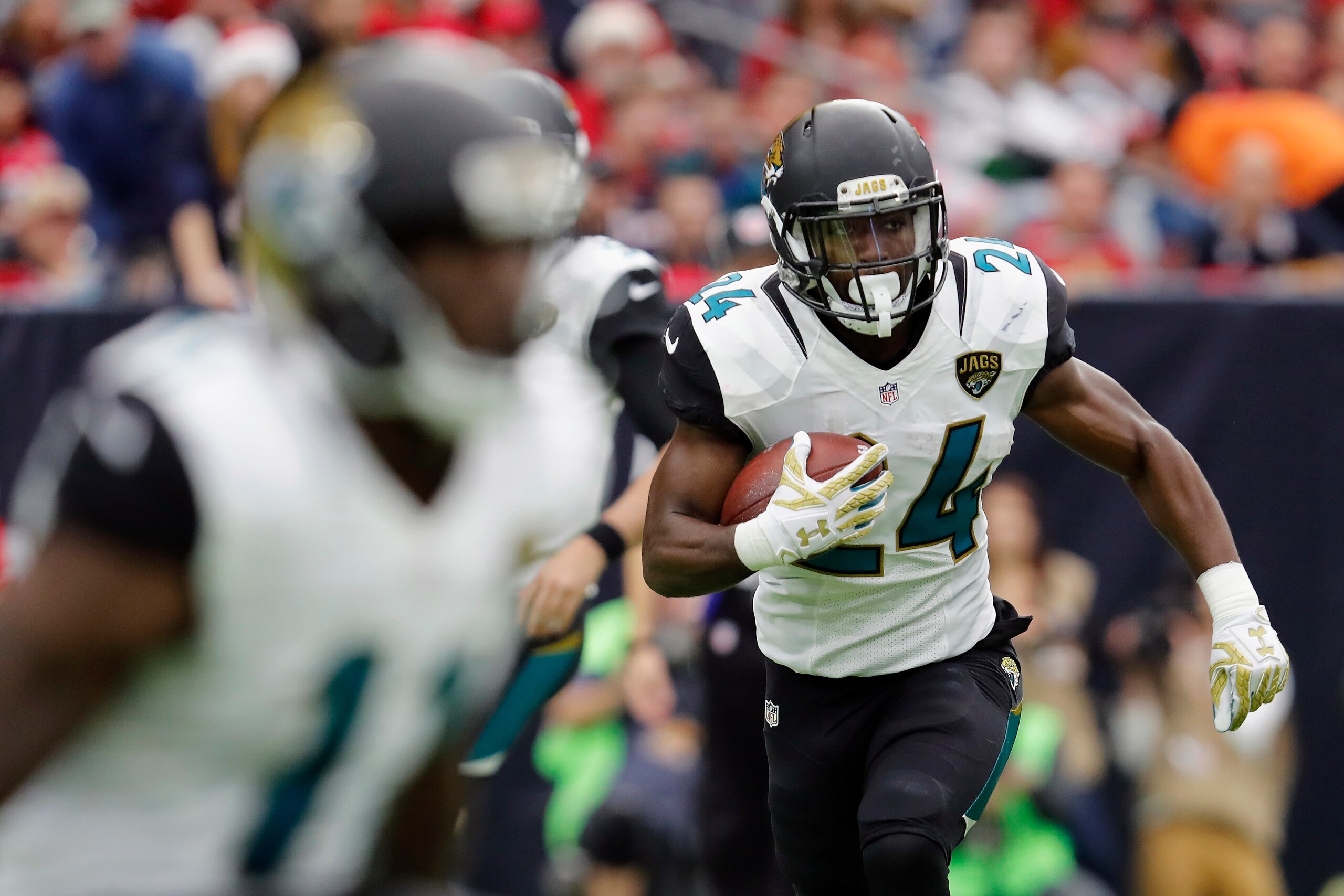 HOUSTON, TX - DECEMBER 18: T.J. Yeldon #24 of the Jacksonville Jaguars runs the ball against the Houston Texans in the third quarter at NRG Stadium on December 18, 2016 in Houston, Texas. (Photo by Tim Warner/Getty Images)