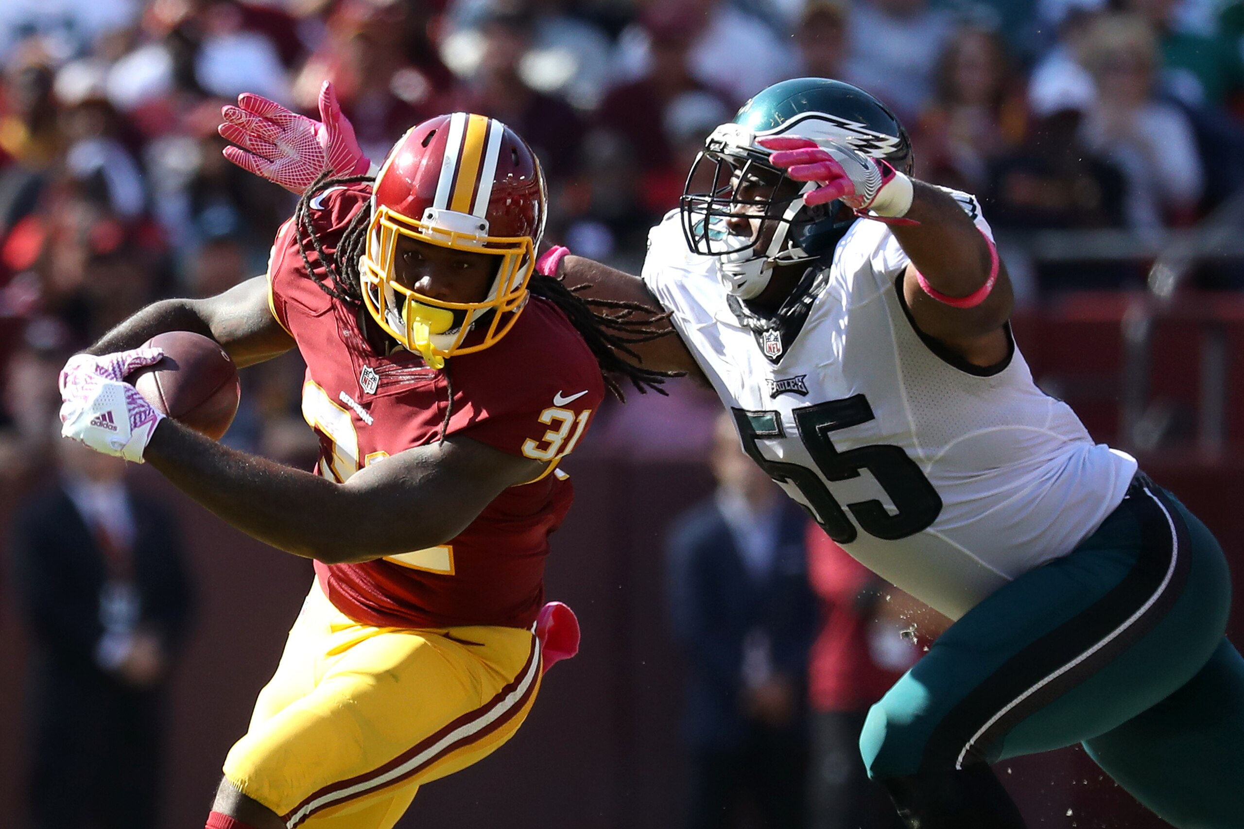 LANDOVER, MD - OCTOBER 16: Running back Matt Jones #31 of the Washington Redskins carries the ball against defensive end Brandon Graham #55 of the Philadelphia Eagles in the second quarter at FedExField on October 16, 2016 in Landover, Maryland. (Photo by
