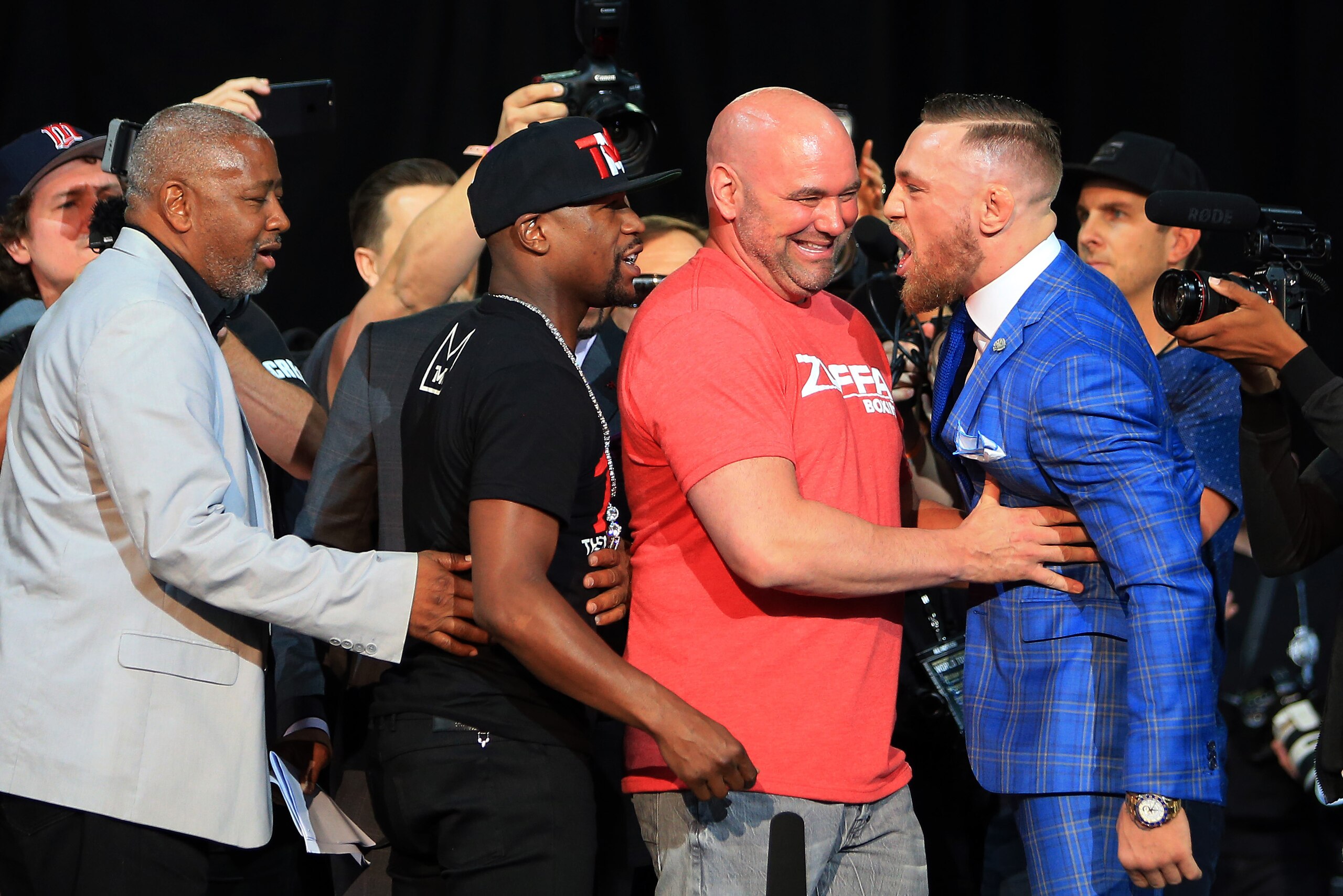 TORONTO, ON - JULY 12:  UFC President Dana White steps in as Floyd Mayweather Jr. and Conor McGregor faceoff during the Floyd Mayweather Jr. v Conor McGregor World Press Tour at Budweiser Stage on July 12, 2017 in Toronto, Canada.  (Photo by Vaughn Ridley