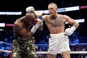LAS VEGAS, NV - AUGUST 26:  (R-L) Conor McGregor throws a punch at Floyd Mayweather Jr. during their super welterweight boxing match on August 26, 2017 at T-Mobile Arena in Las Vegas, Nevada.  (Photo by Christian Petersen/Getty Images)